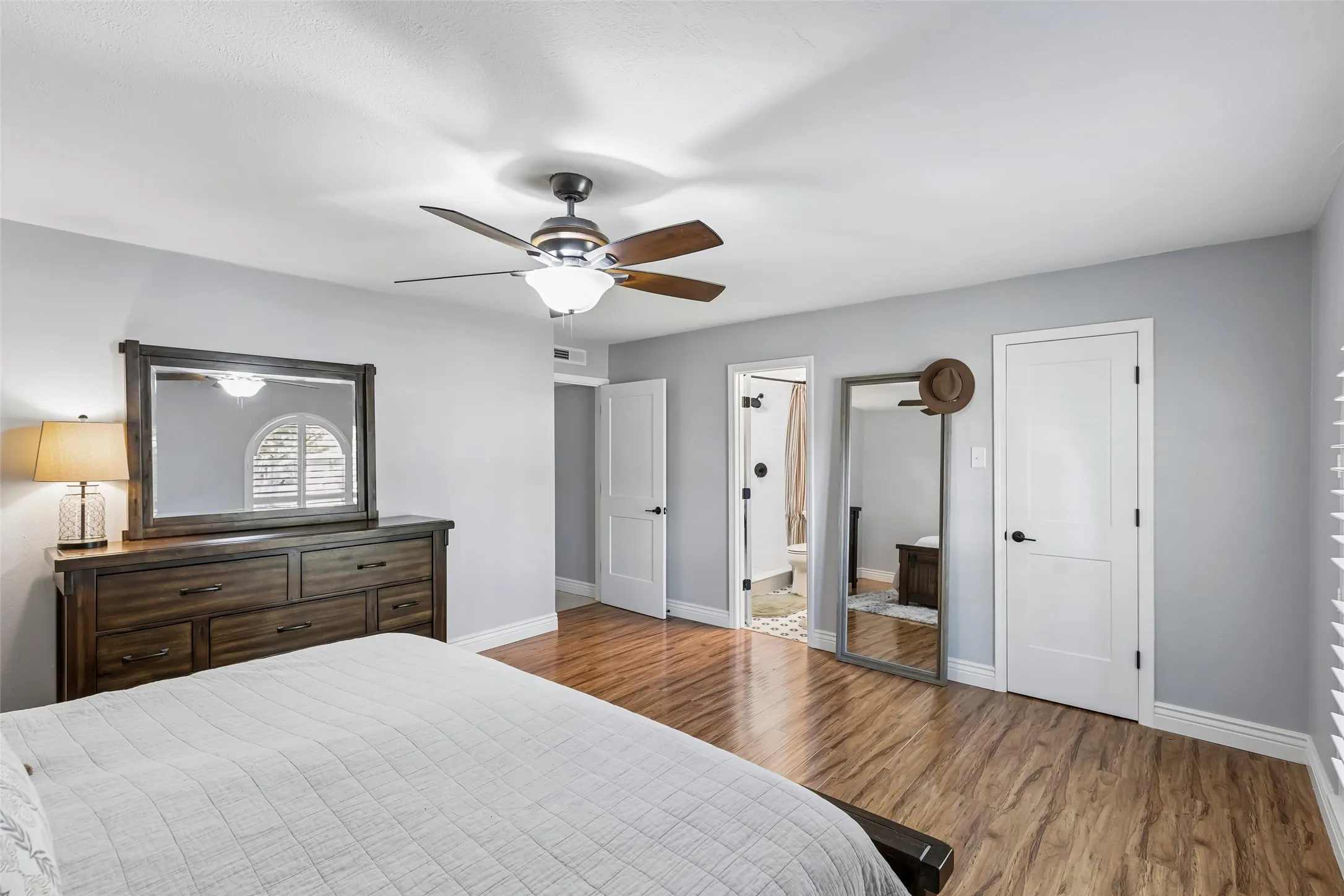The primary suite links the bedroom straight through to the bath and walk-in closet — its own self-contained wing.