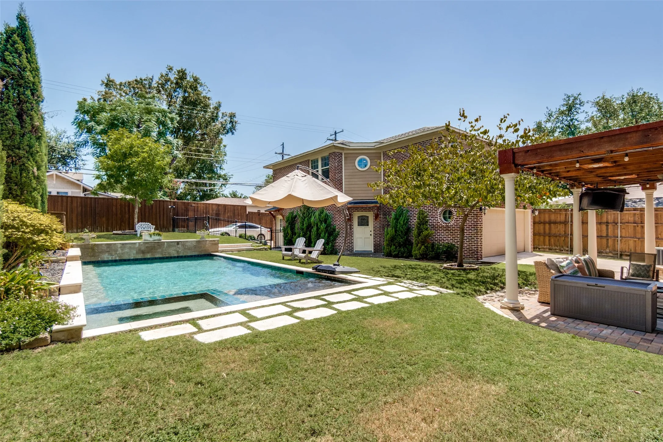 Rectangular in-ground pool with surrounding stone coping