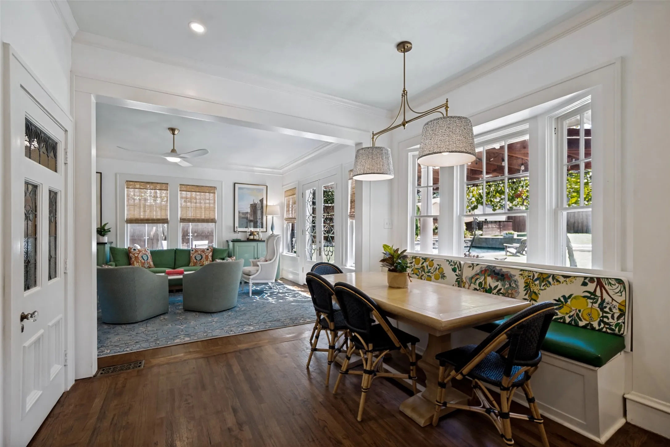Hardwood-finish flooring, built-in window seating, decorative pendant lighting, and an open-concept layout