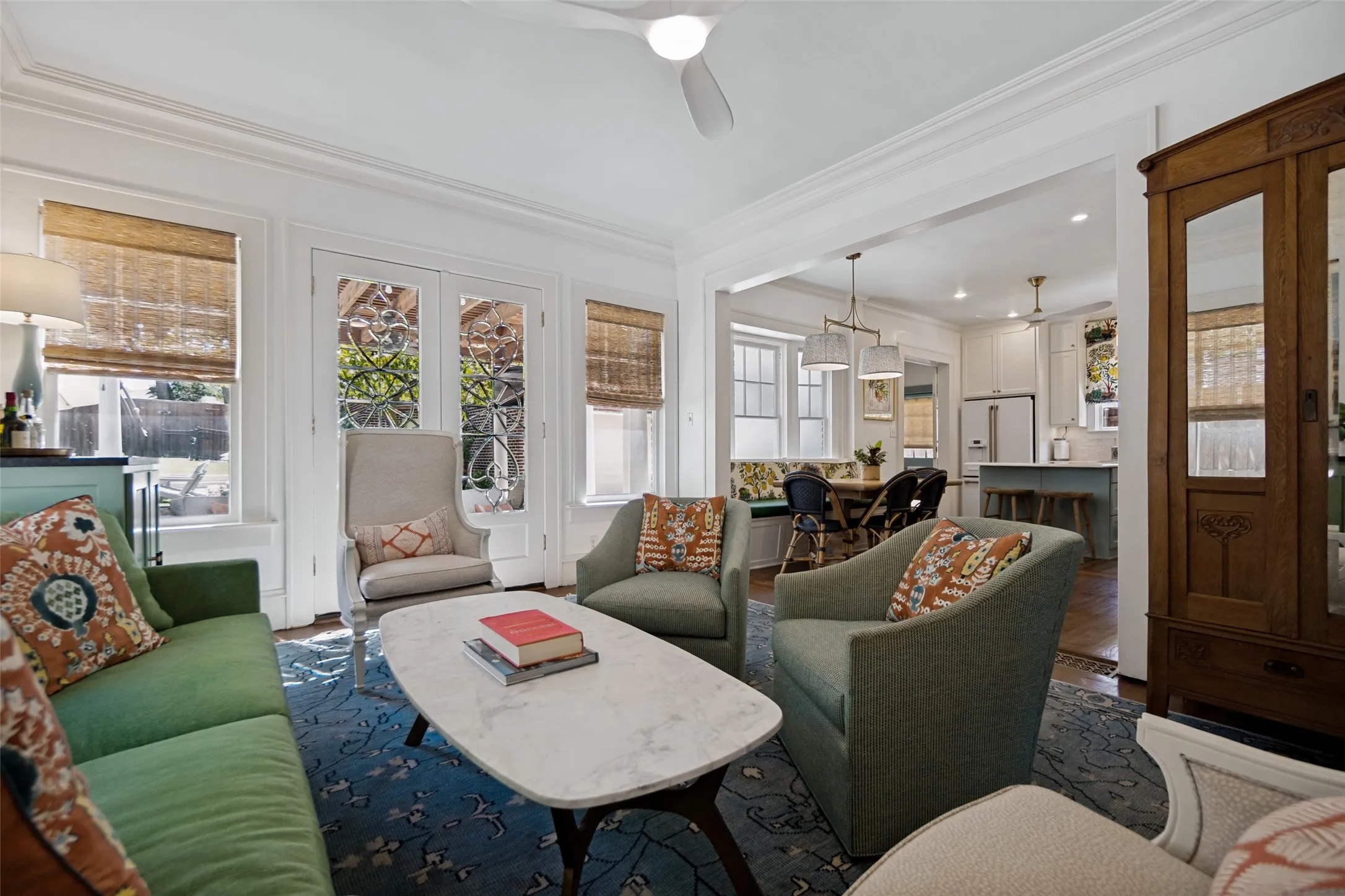 Living space with crown molding, double French doors, wood-finish flooring, and recessed lighting