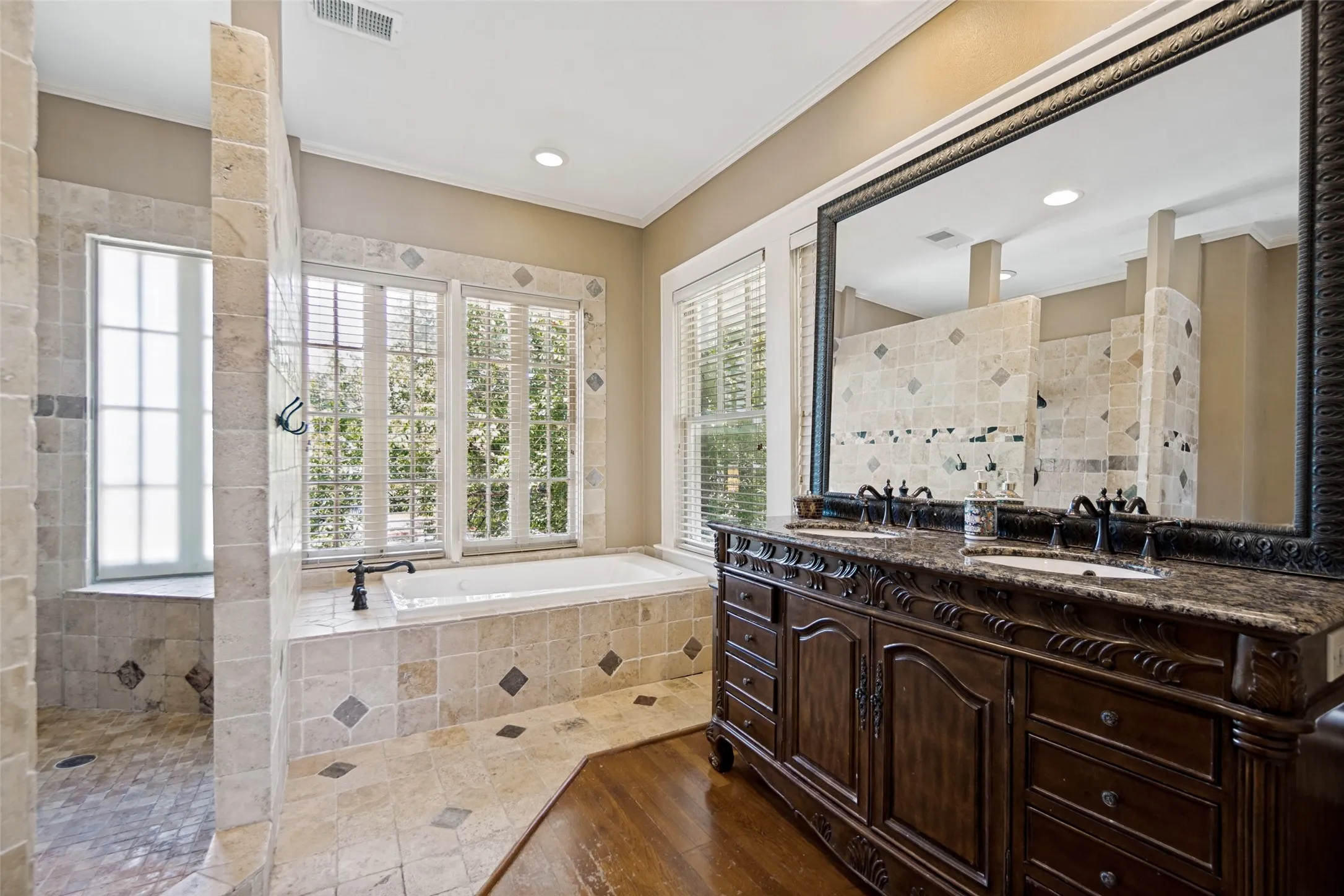 Dual vanity with dark wood cabinetry and stone countertop