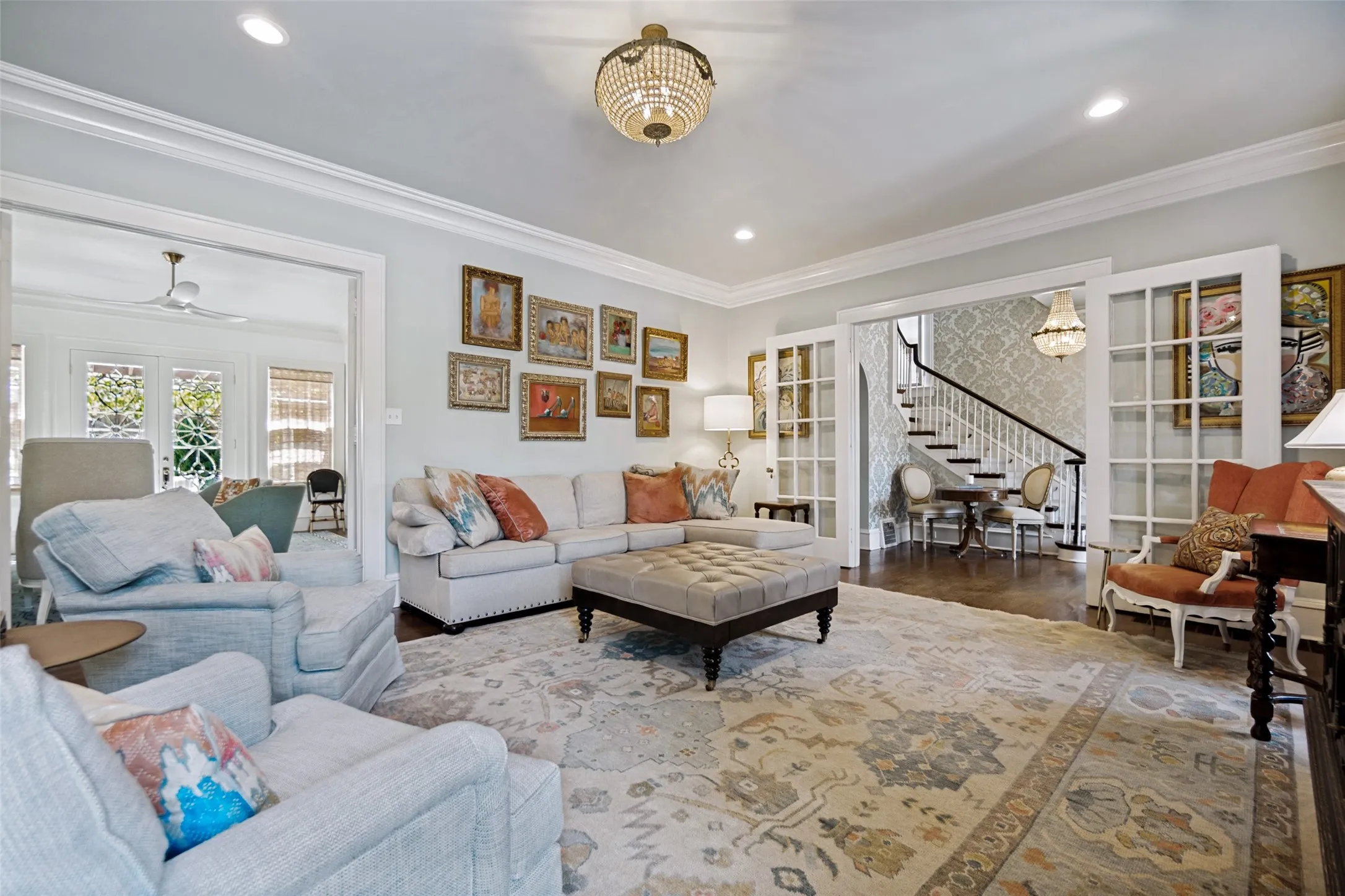 Recessed lighting, crown molding, wood-finish flooring, French doors, and a chandelier