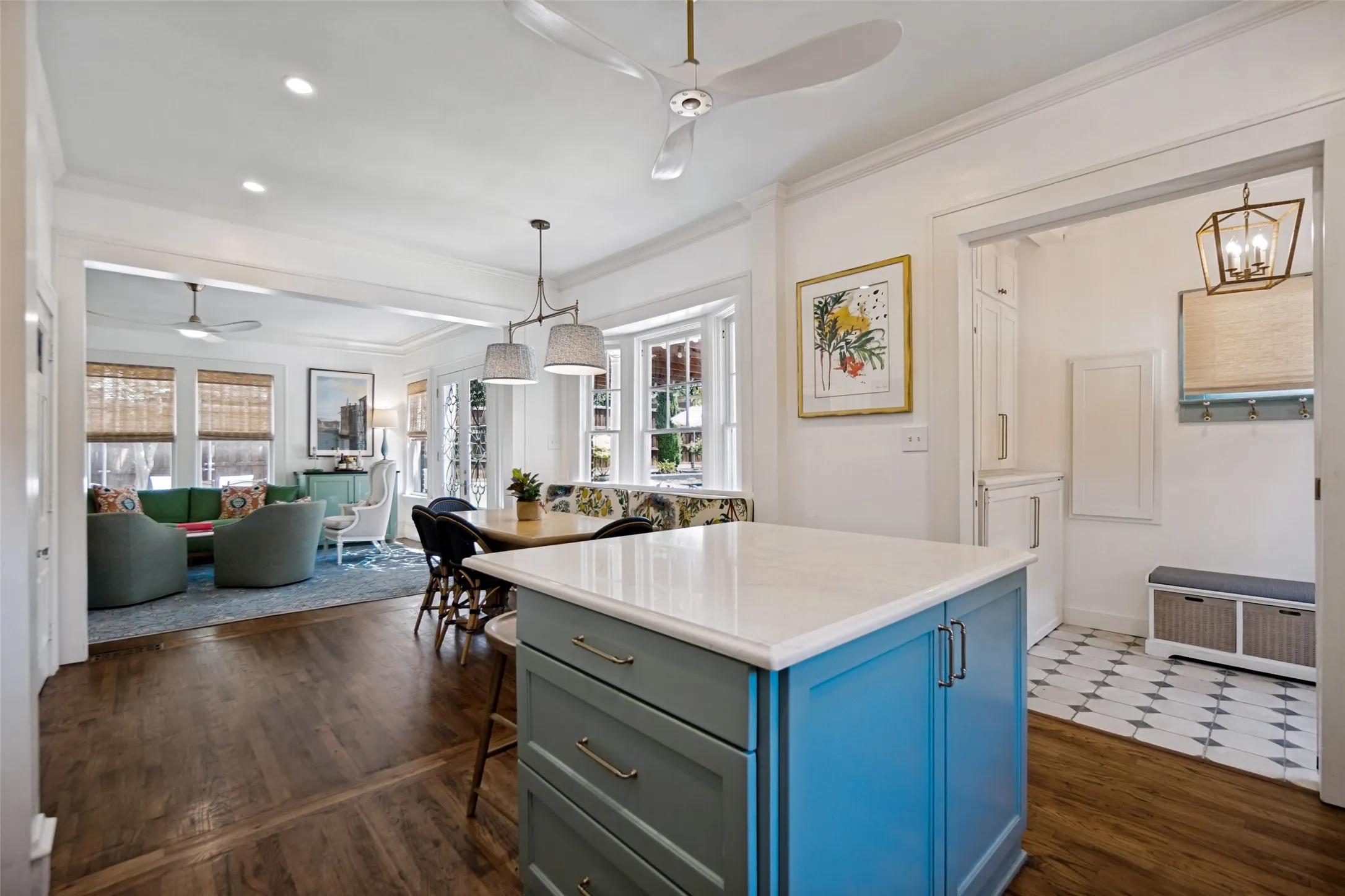 Kitchen island with a light-colored countertop and painted cabinetry