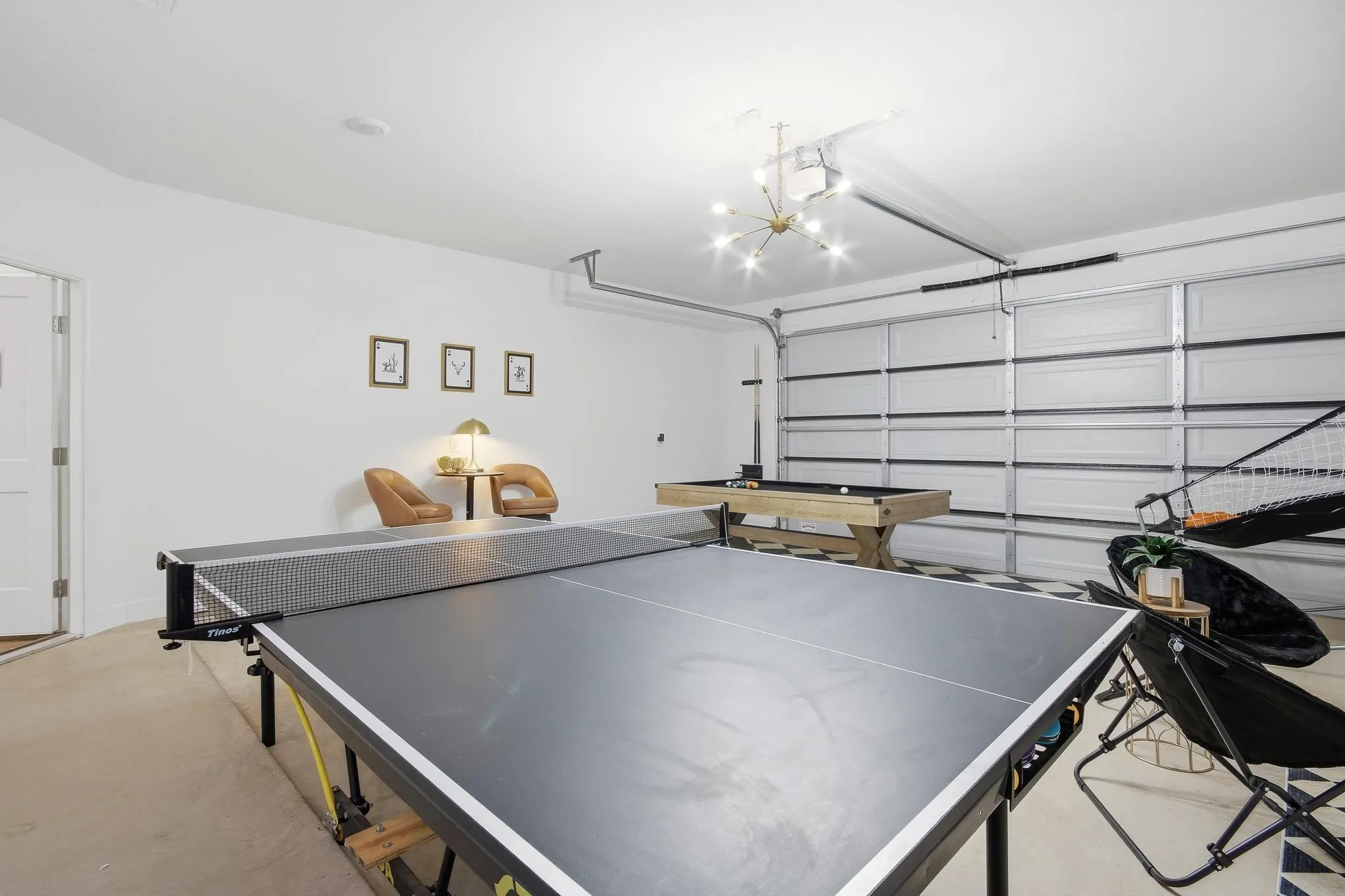 Attached two-car garage with overhead lighting and a finished concrete floor