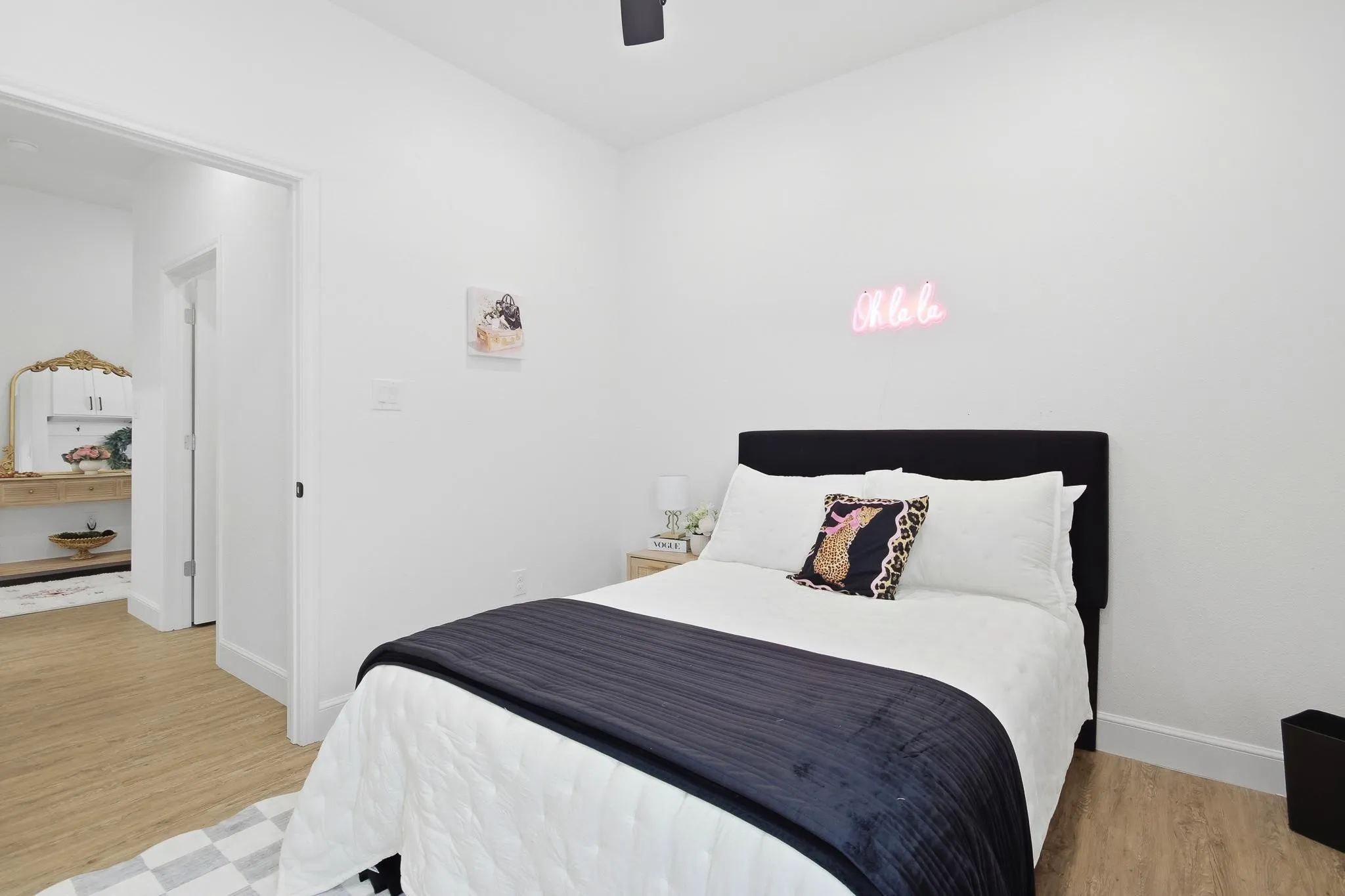 Light wood-finish flooring with white baseboards and walls