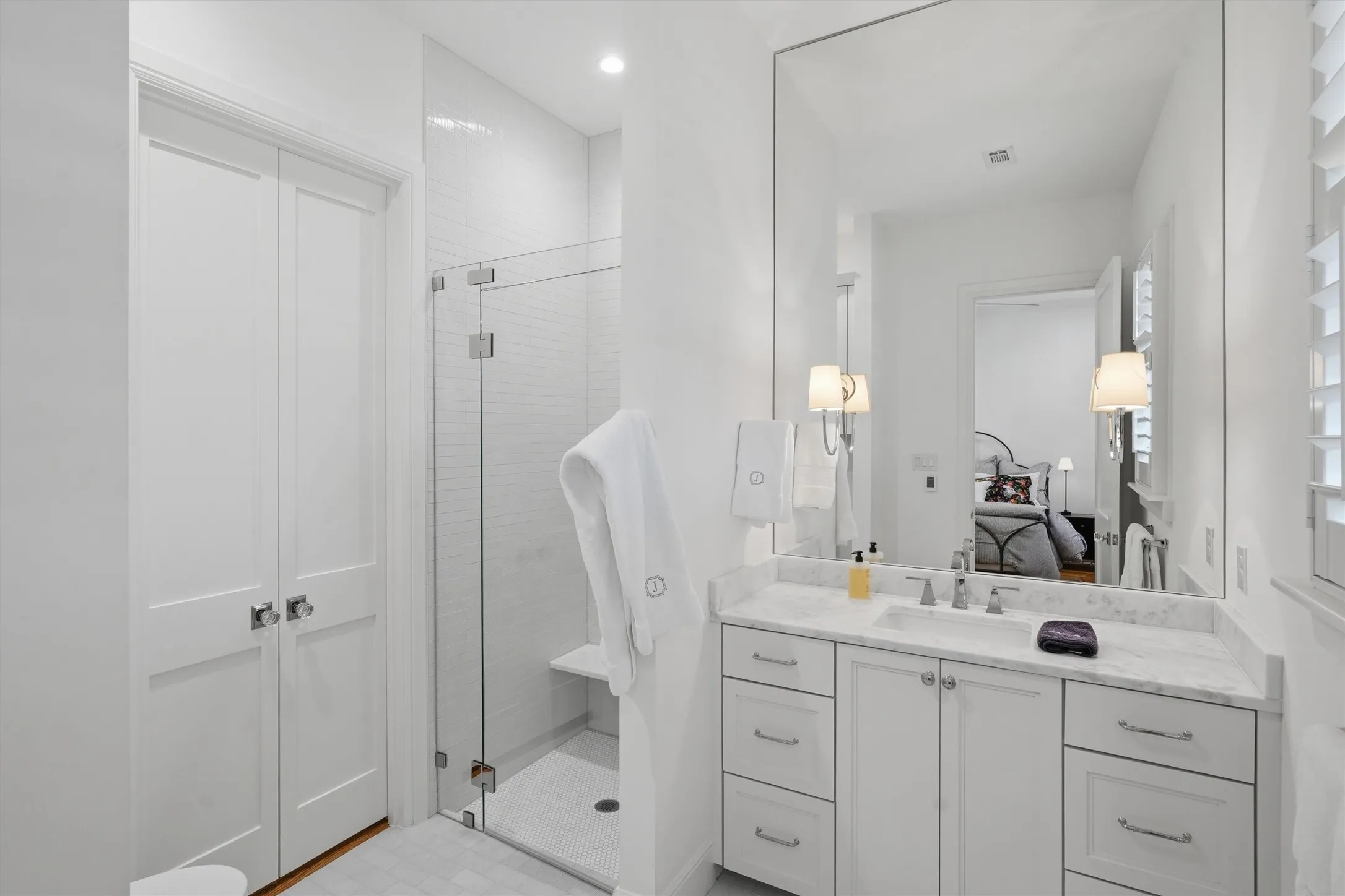 Bathroom with heated floors, walk in shower and custom closet.