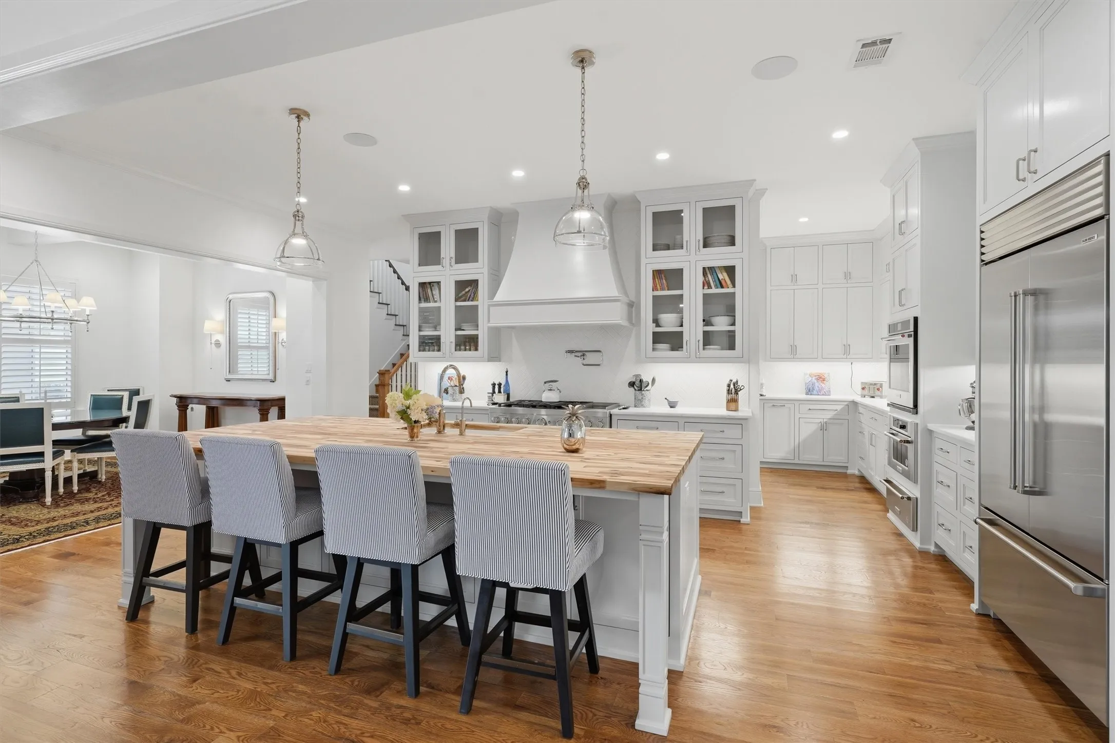 The chefs kitchen is complete with 3 ovens, a 6-burner gas range, pot filler, Sub-Zero refrigerator and wine fridge, built-in nugget ice maker, and 2 dishwashers.