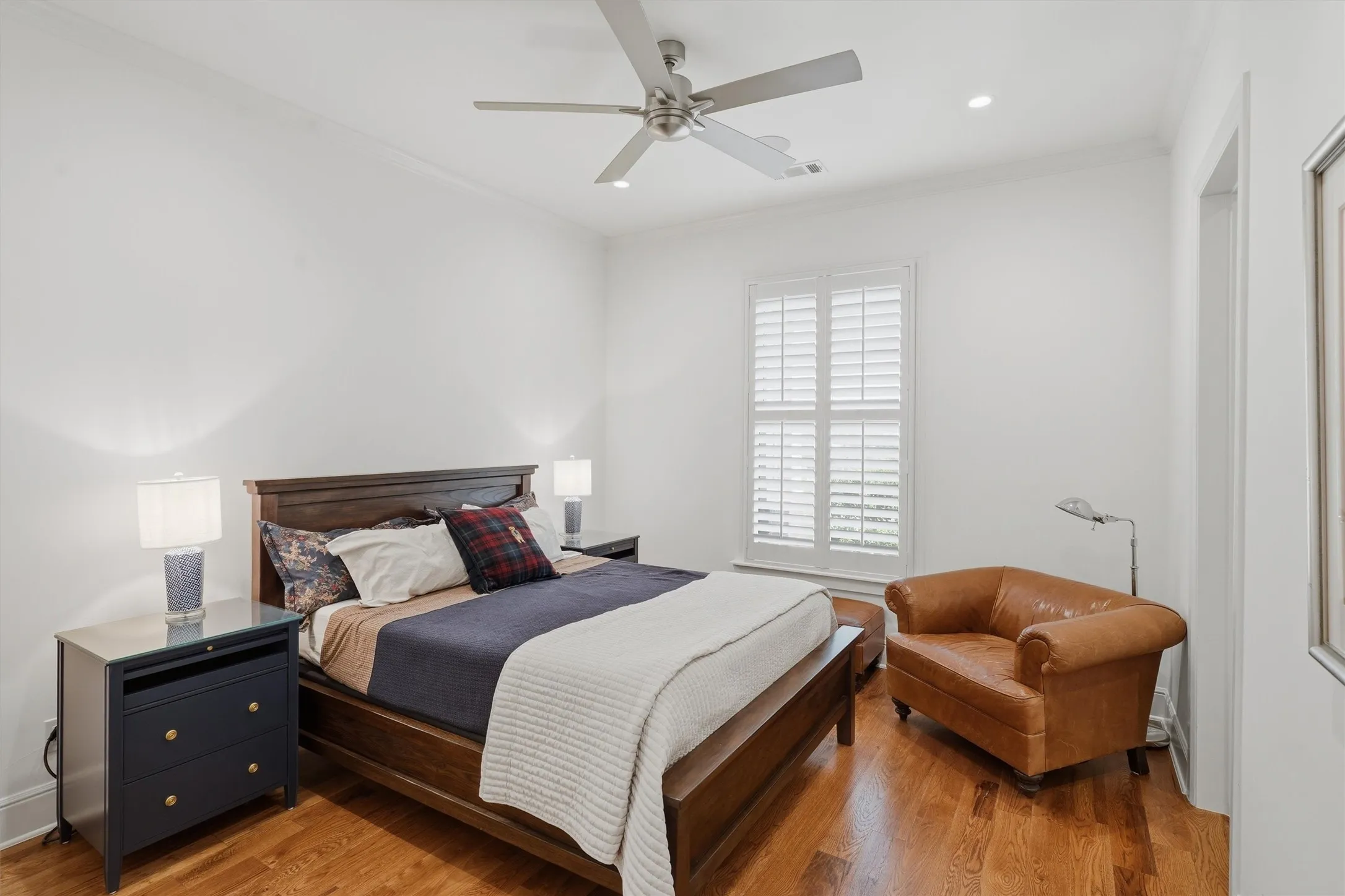 En-Suite Bedroom with white oak floors, plantation shutters and a custom closet.
