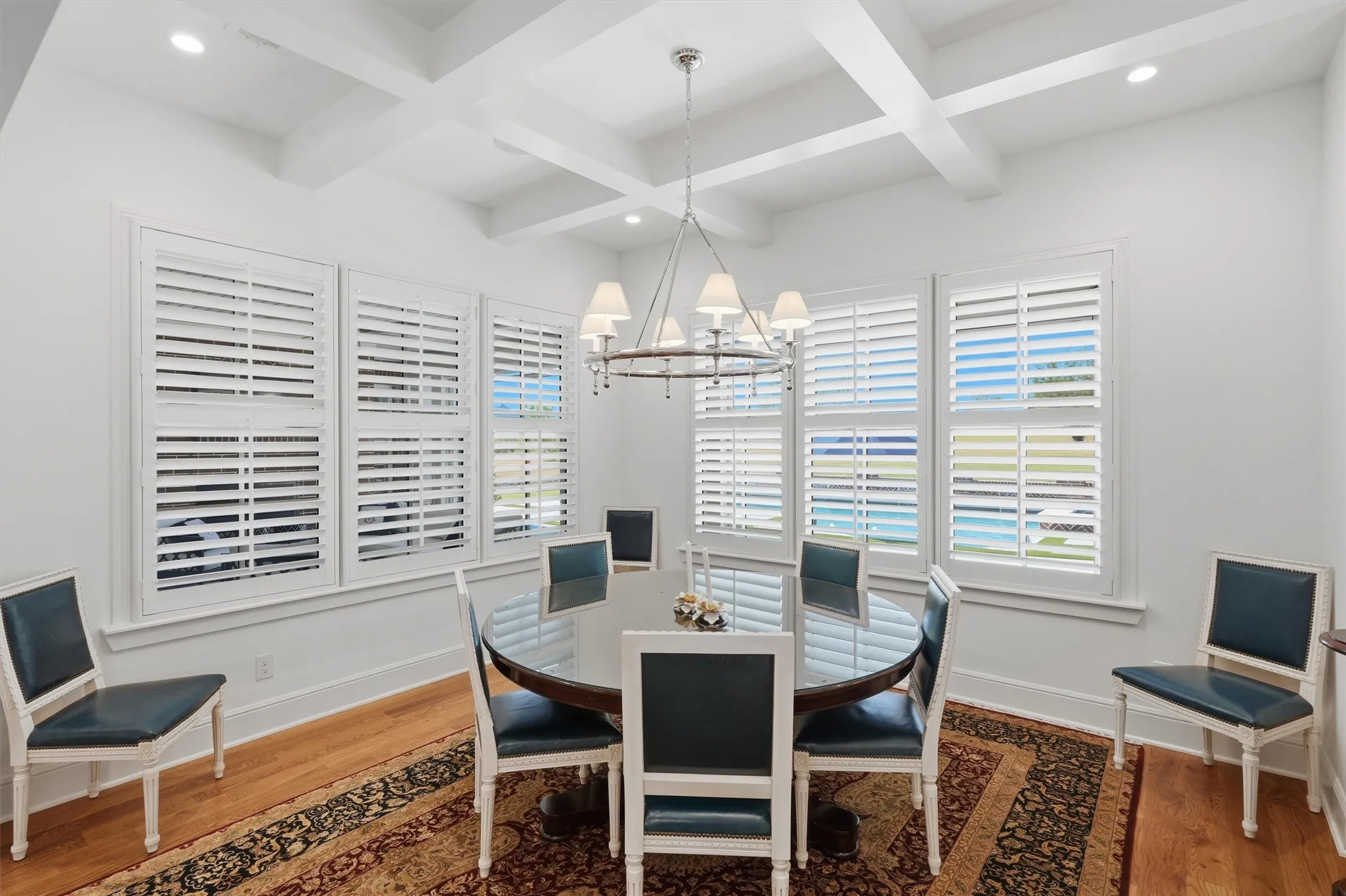 The dining area is flooded with natural light and is open to the living room and kitchen.