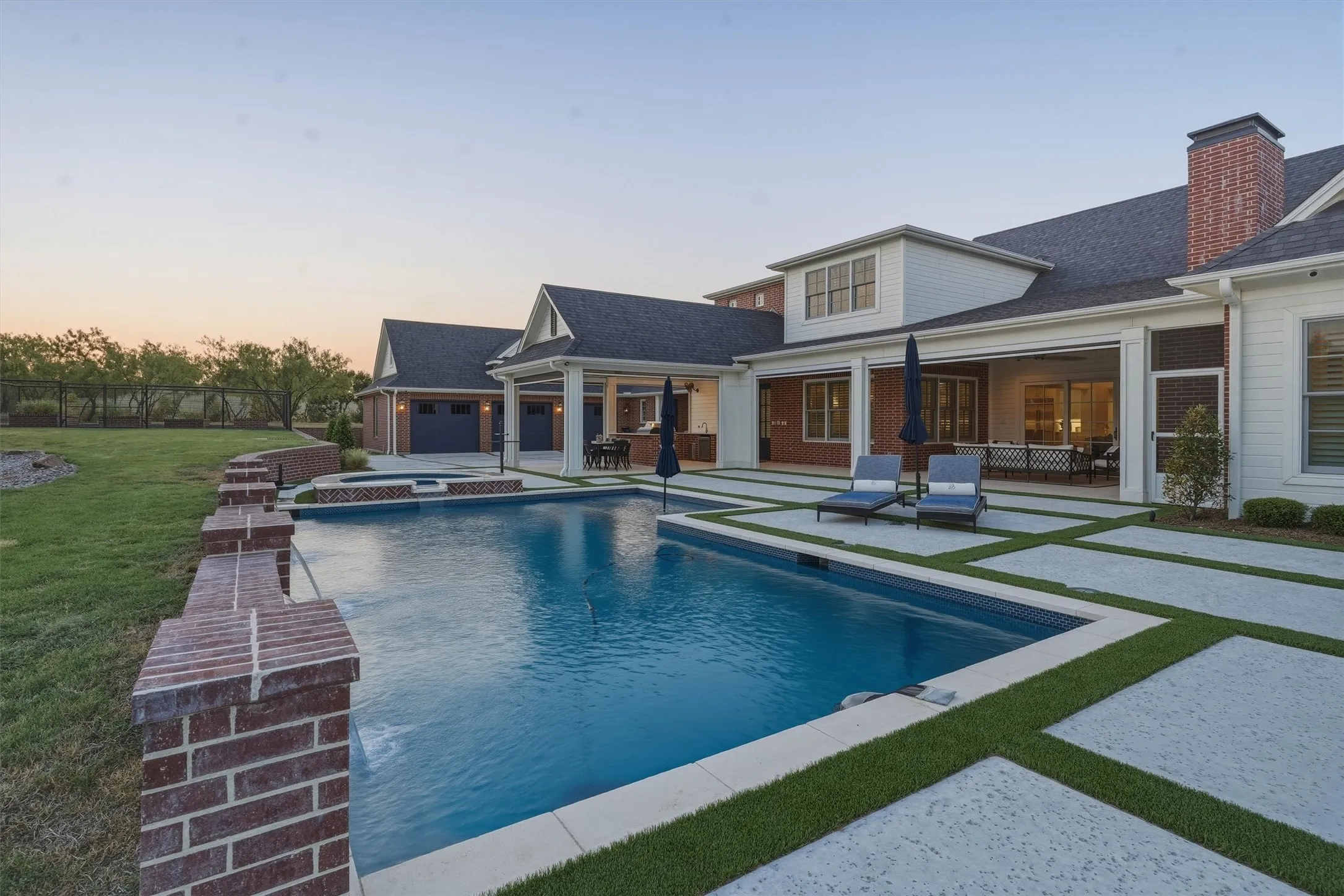 The beautiful resort like pool has a spa with water features. There is an outdoor living area, outdoor kitchen, and covered dining.
