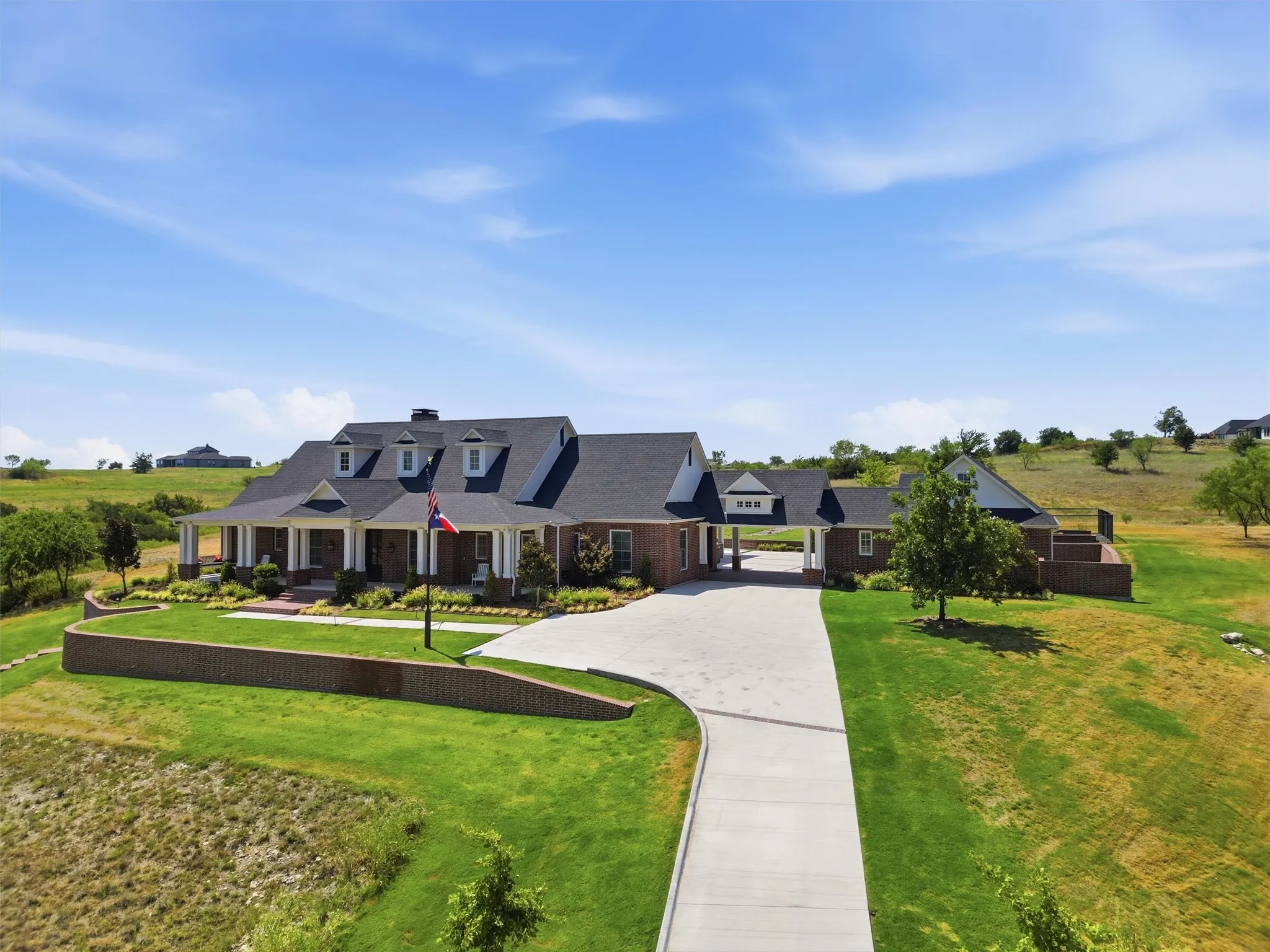 This beautiful brick home has a large front porch with a beautiful wood swing to enjoy the views of the private pond sitting on 7.89 acres.
