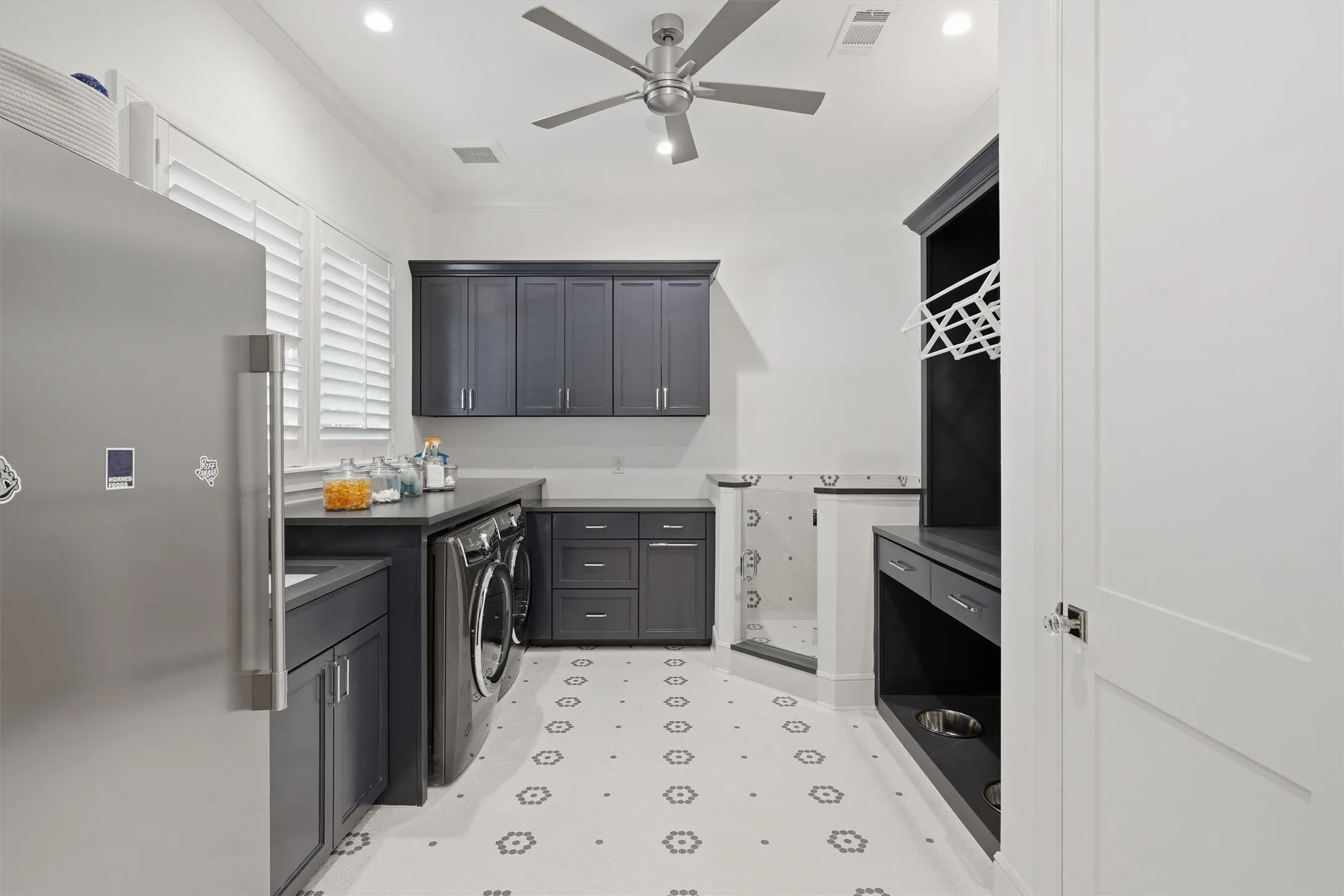 The laundry room offers a freezer, dog wash, and dedicated dog feeding station with a pop filler for concenience.