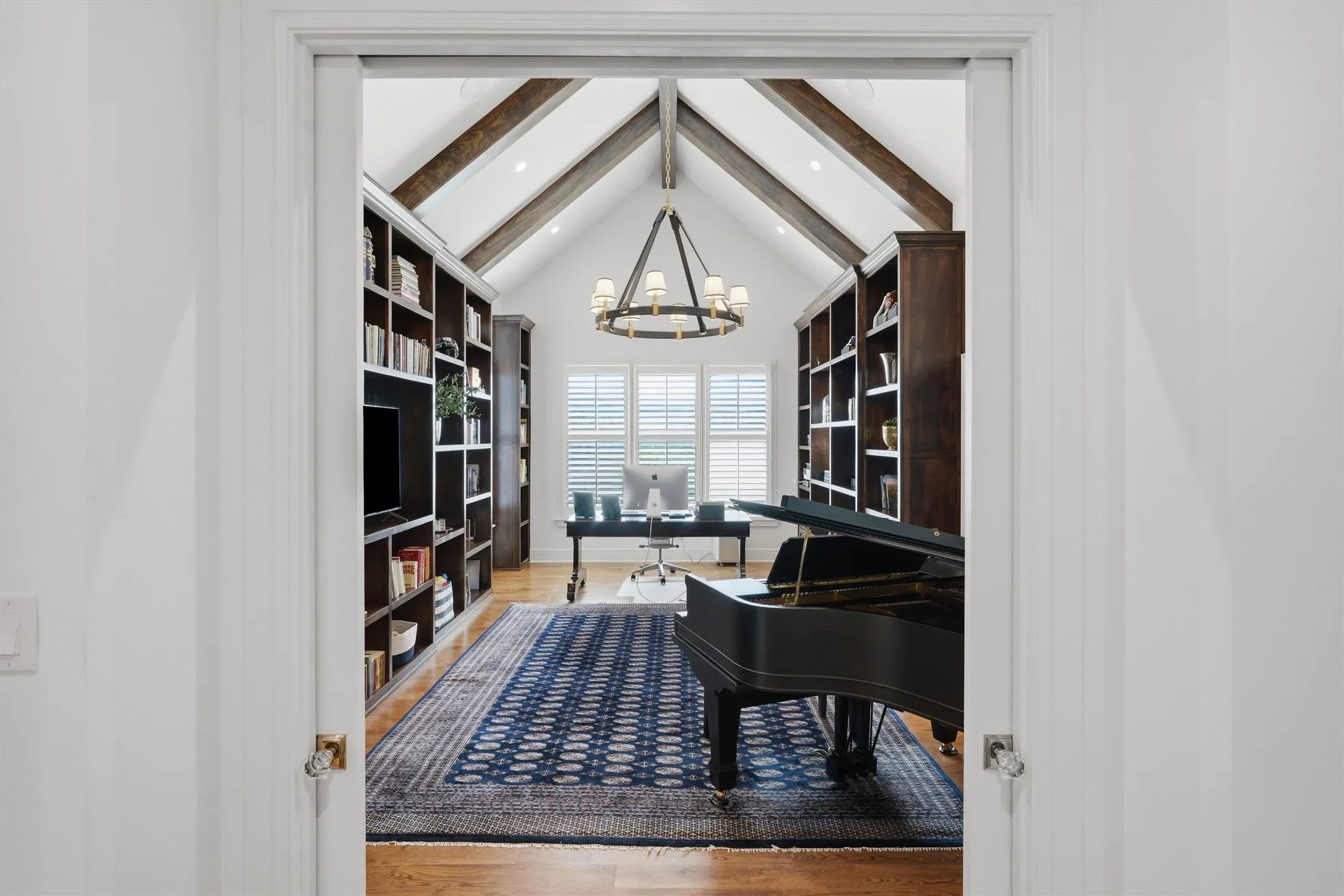 The study offers warm wood beams, floor to ceiling built ins, and a built in tornado shelter.