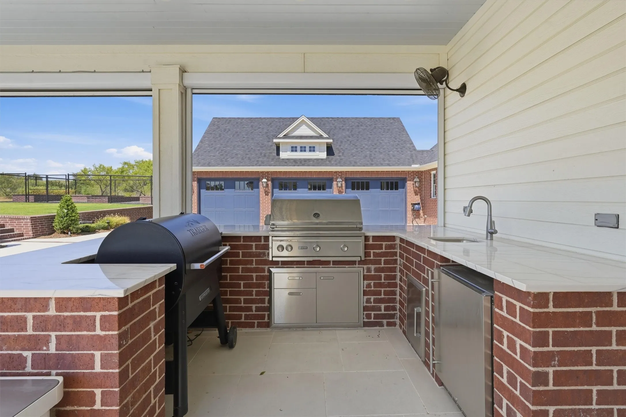 This outdoor kitchen area is perfect for your days outside! It offers a traeger smoker and grill