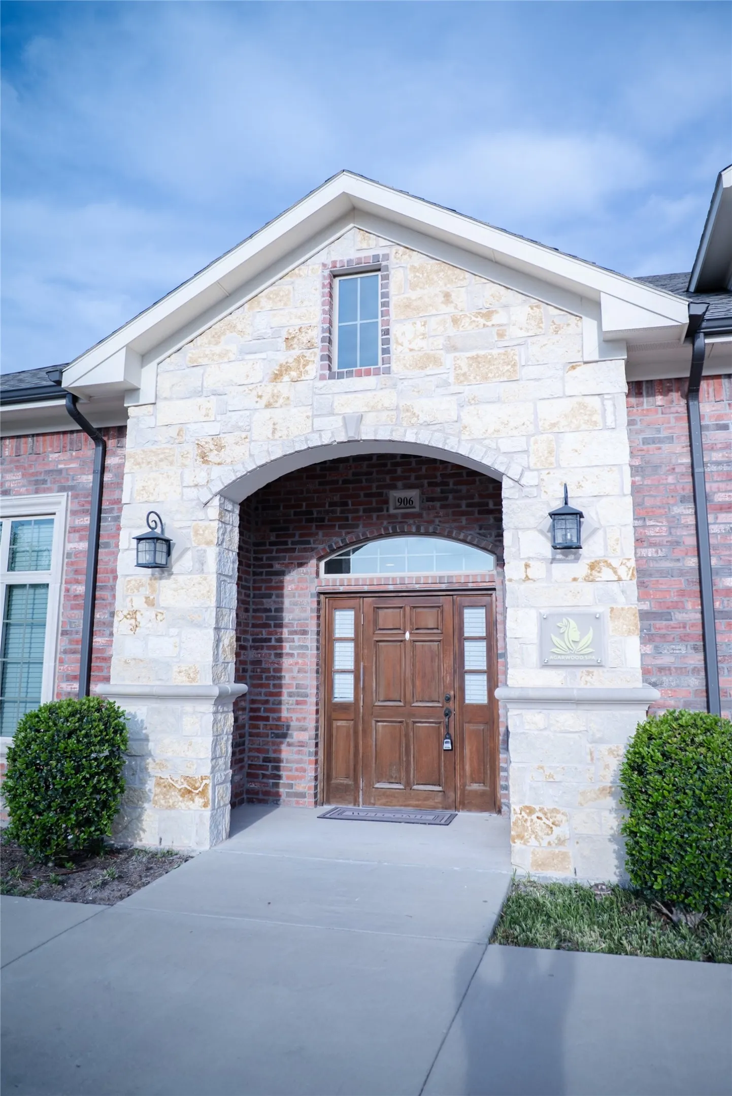 Brick and stone facade featuring an arched entryway