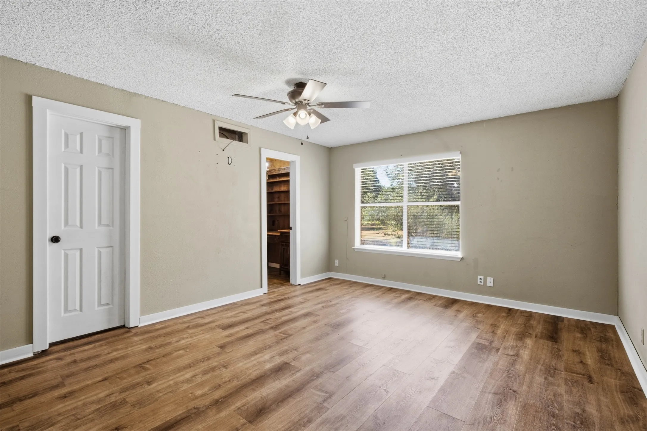 Primary bedroom with view of pretty yard