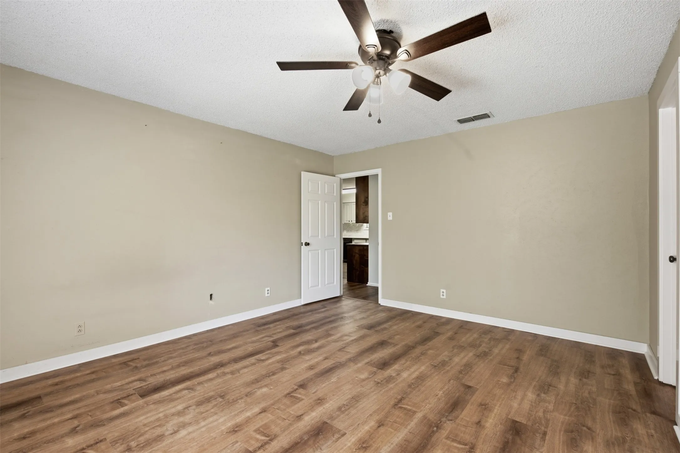 Primary bedroom has beautiful LVP wood-look floors