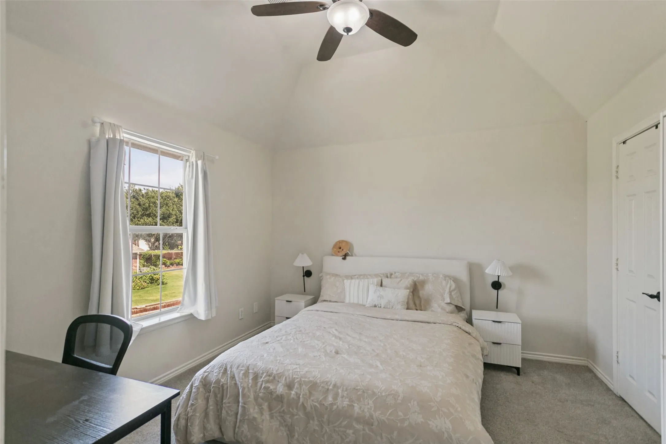 Vaulted ceiling with a ceiling fan, carpeted flooring, and a single window