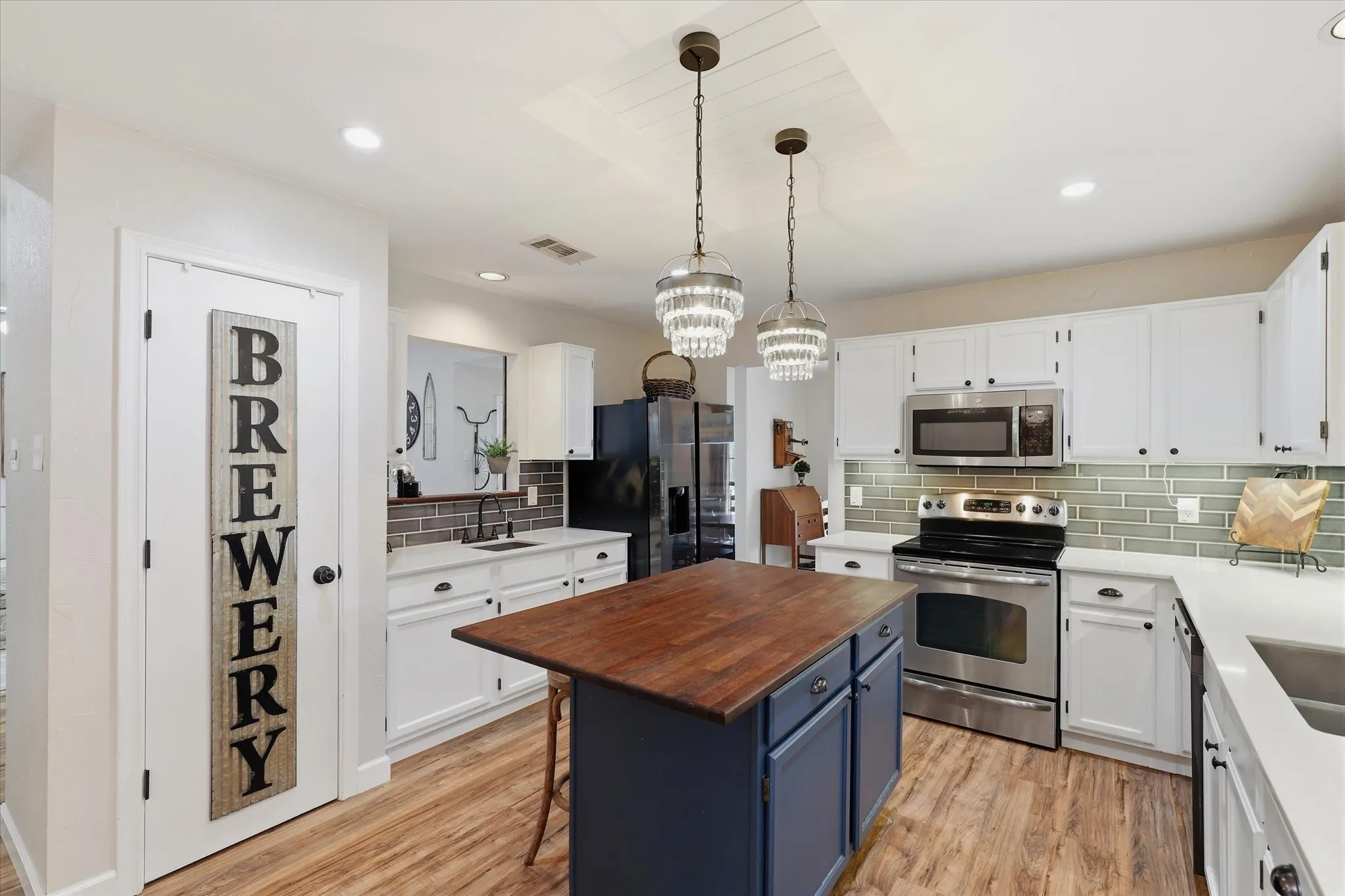 Thoughtfully updated kitchen offers an abundance of cabinetry, quartz countertops, tile backsplash and an easy connection to the dining area.