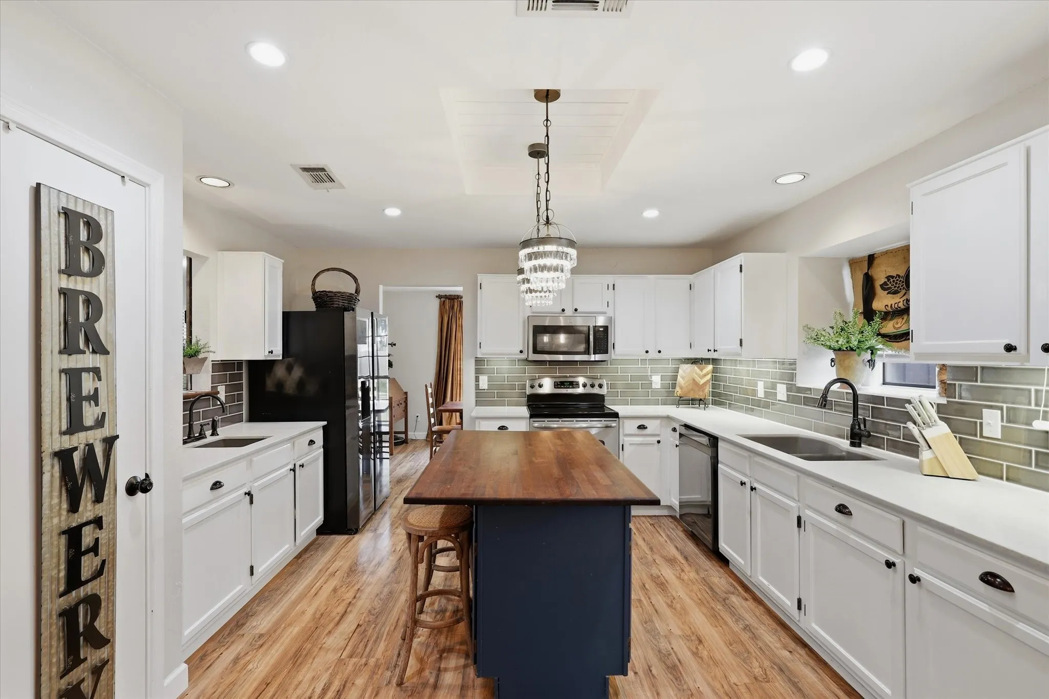 Generous counter space and cabinetry provide plenty of room for meal prep and storage, complemented by quartz countertops and stainless steel appliances.