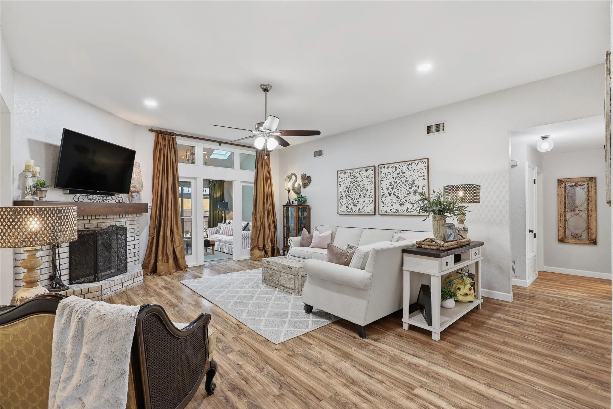 Another view of the generously sized family room showcasing the open flow to the entry and adjoining living spaces.