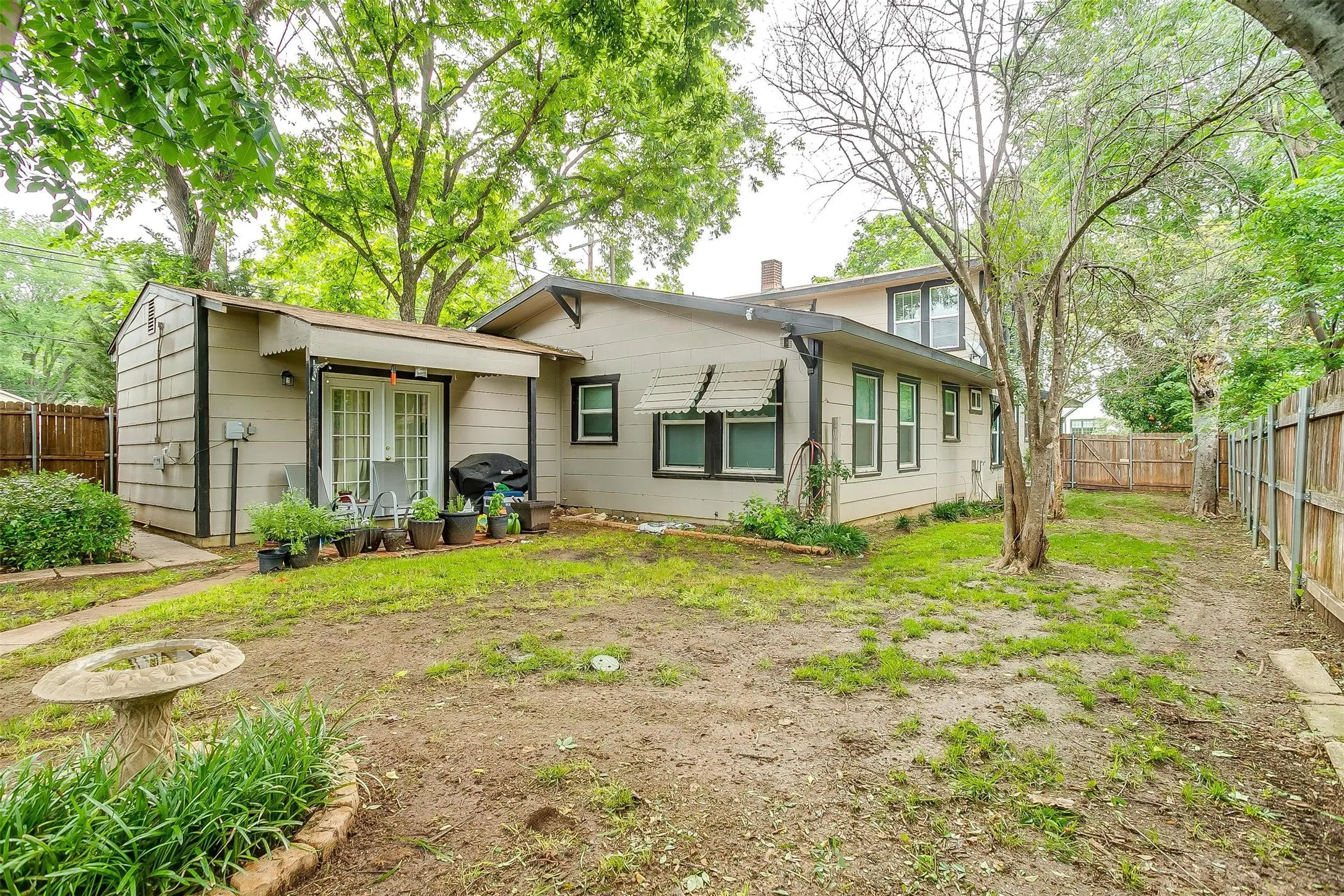 Rear exterior with patio door to the back yard from the middle unit.