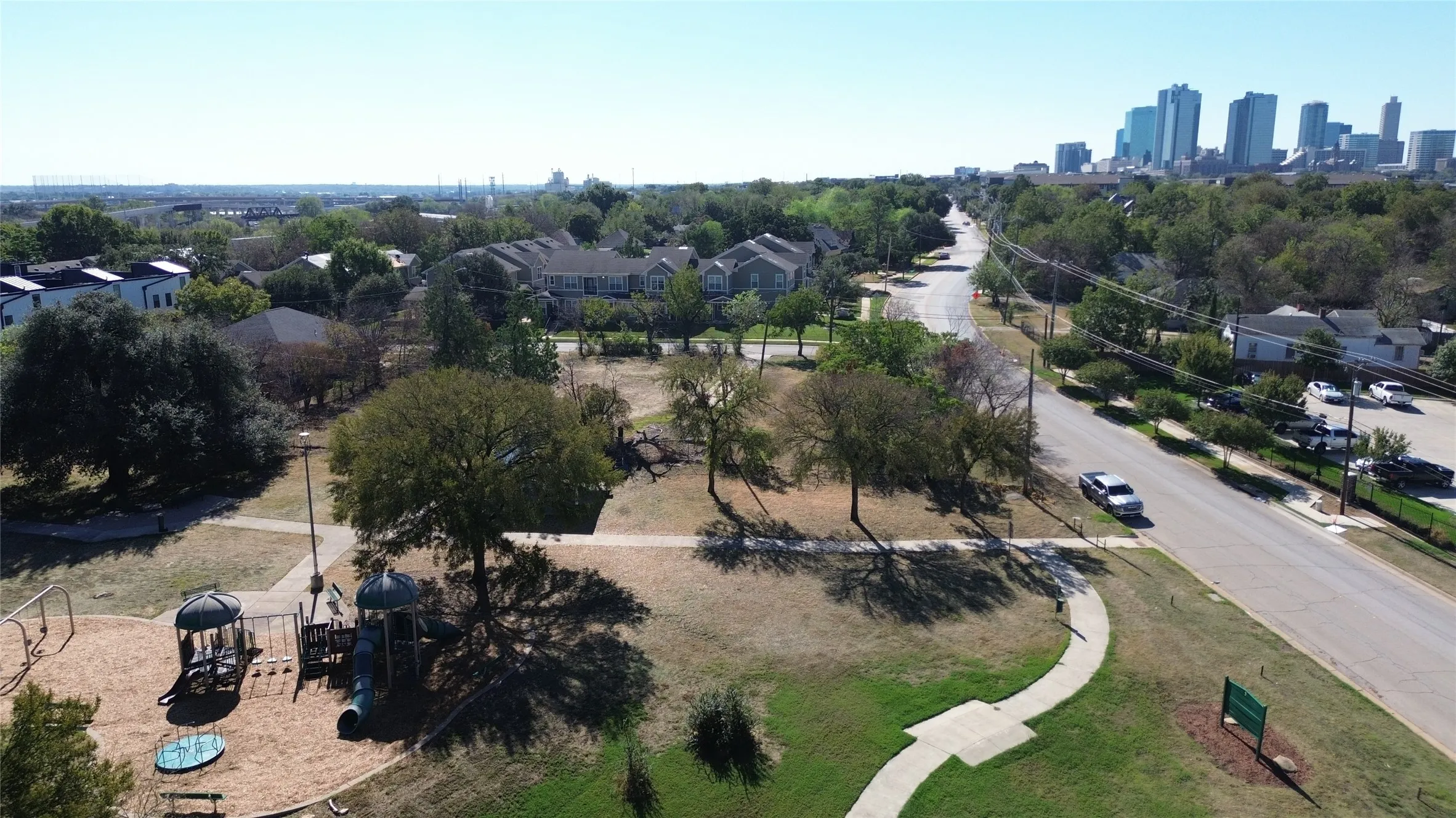 Traders Oak Park with playground, walking paths, & downtown skyline views.