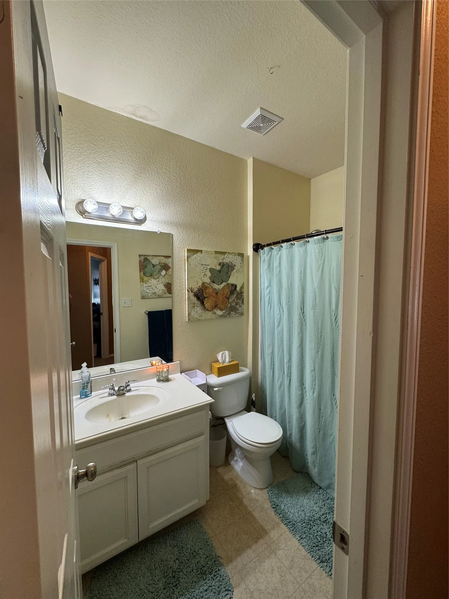 Vanity with integrated sink, chrome faucet, and under-sink storage