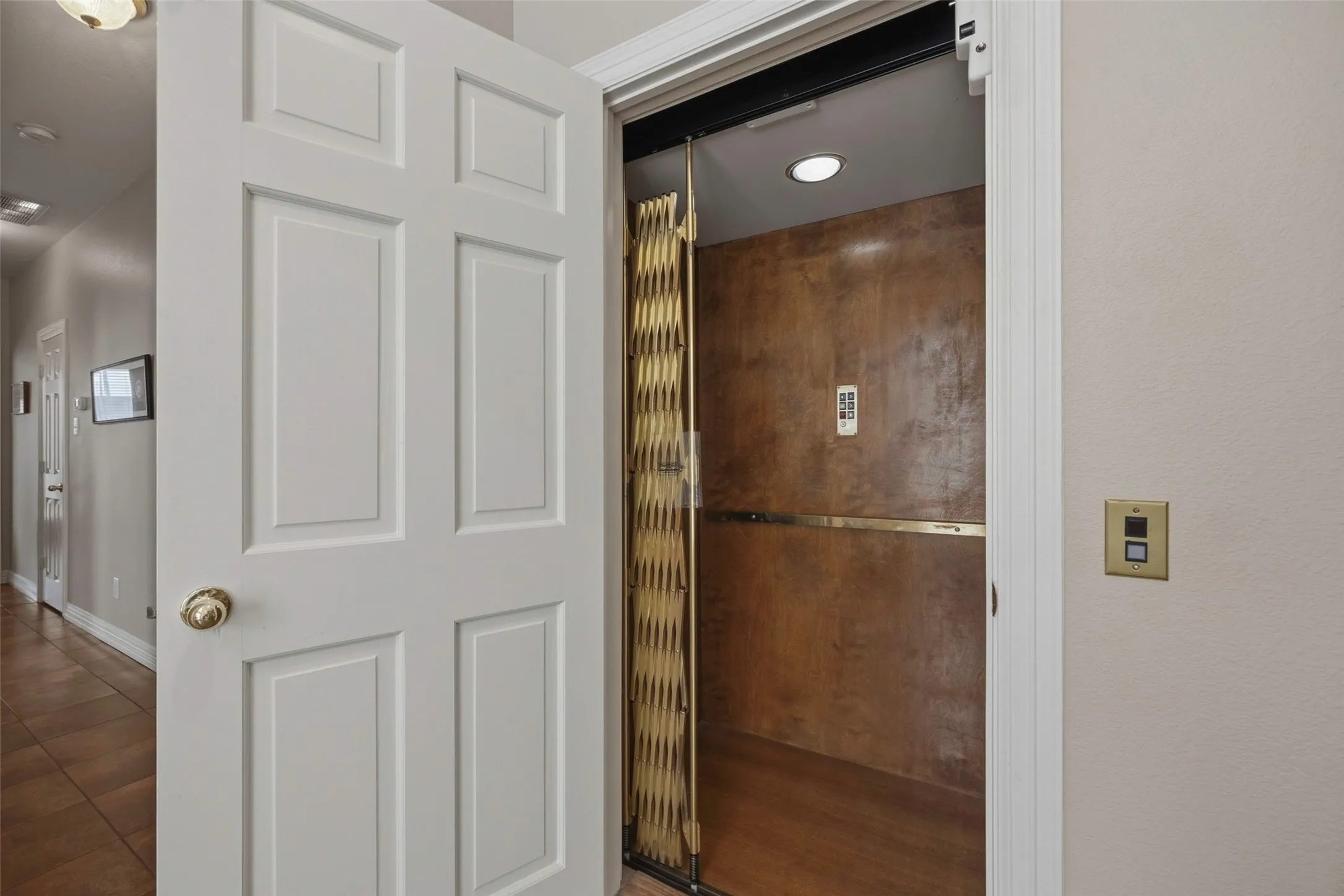 Spa-inspired ensuite featuring a frameless glass shower enclosure with bronze-toned hardware, decorative tile accent wall, recessed ceiling lighting, and wood-finish flooring throughout
