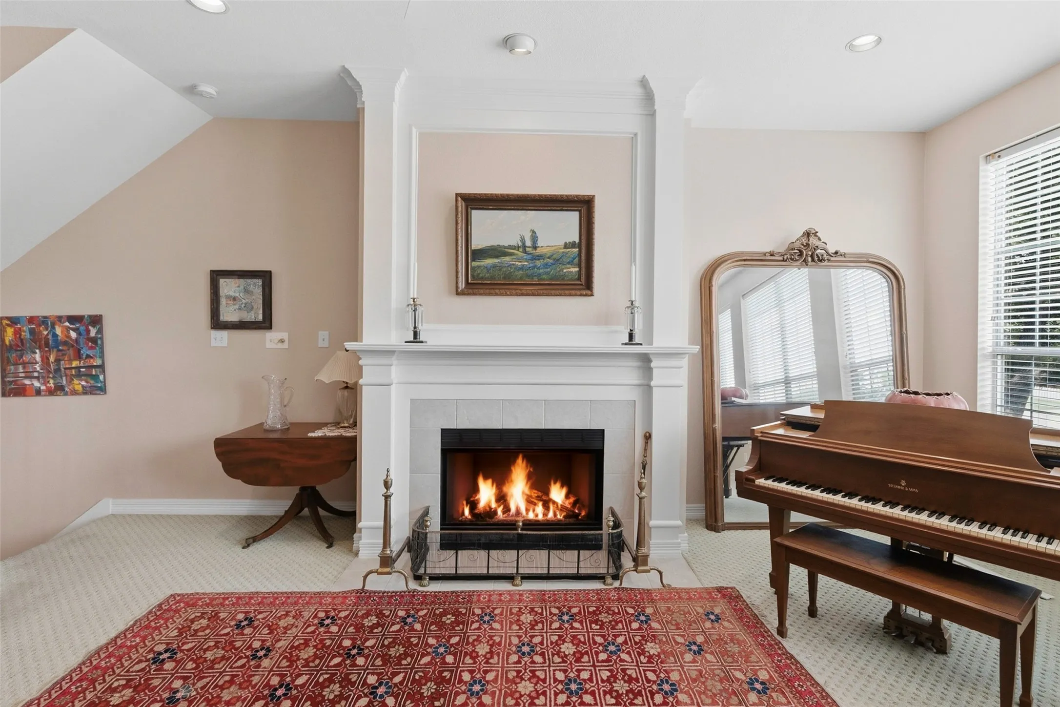Formal fireplace with a white mantel and tile surround, recessed lighting, and carpeted flooring