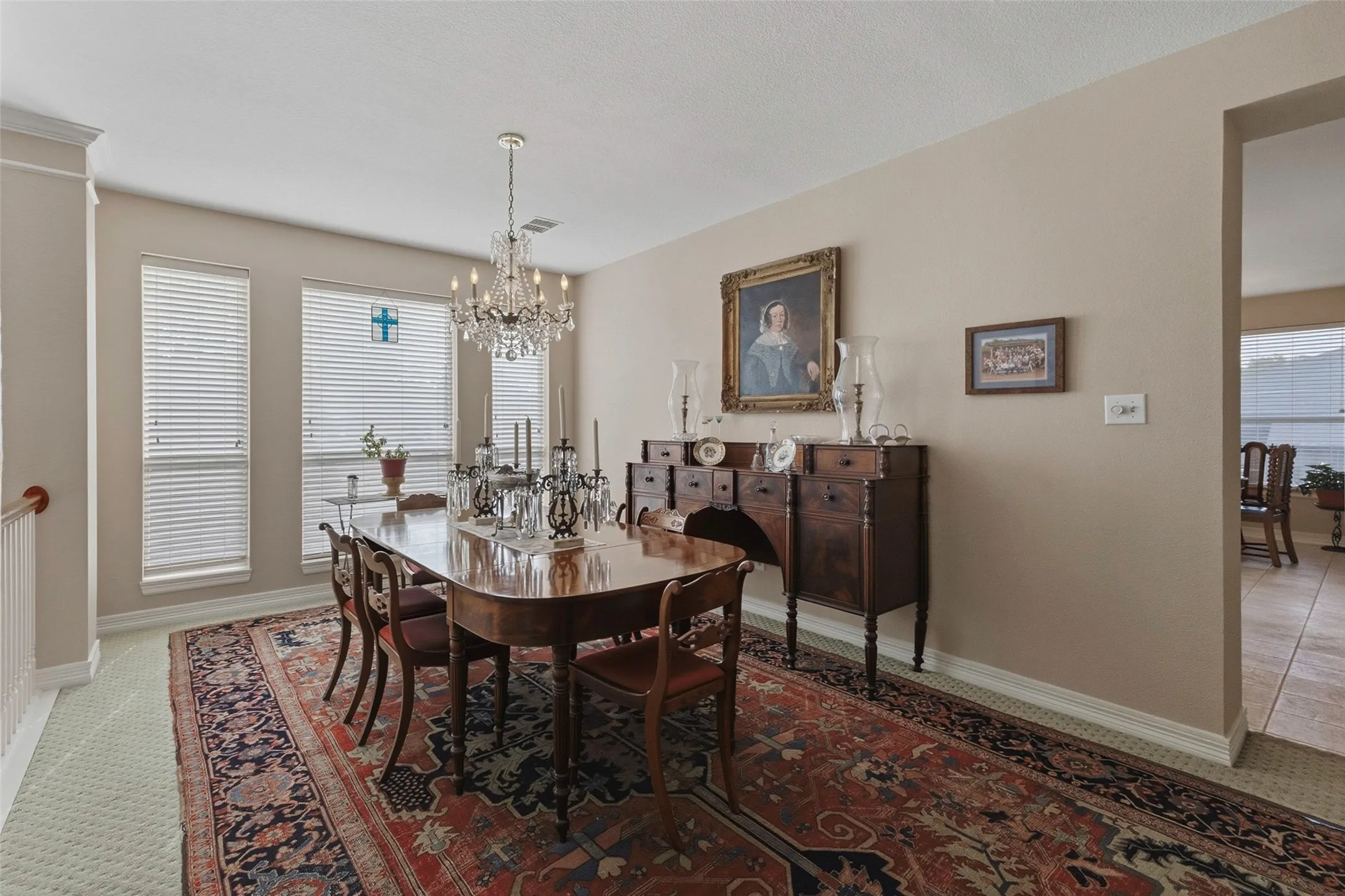 Dining area featuring a crystal chandelier, multiple windows, and a wide entryway