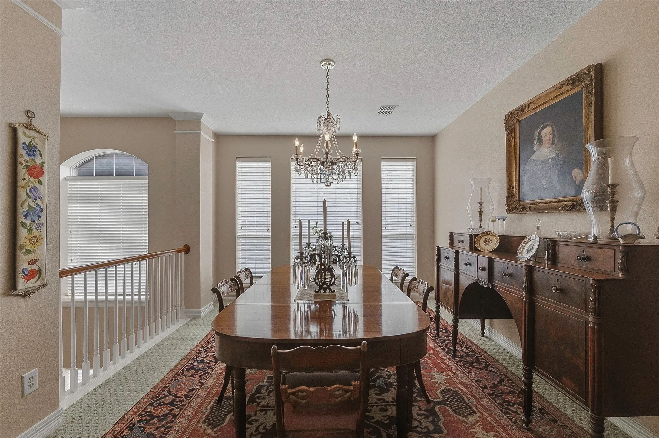 Formal dining area featuring a chandelier, multiple windows, and crown molding