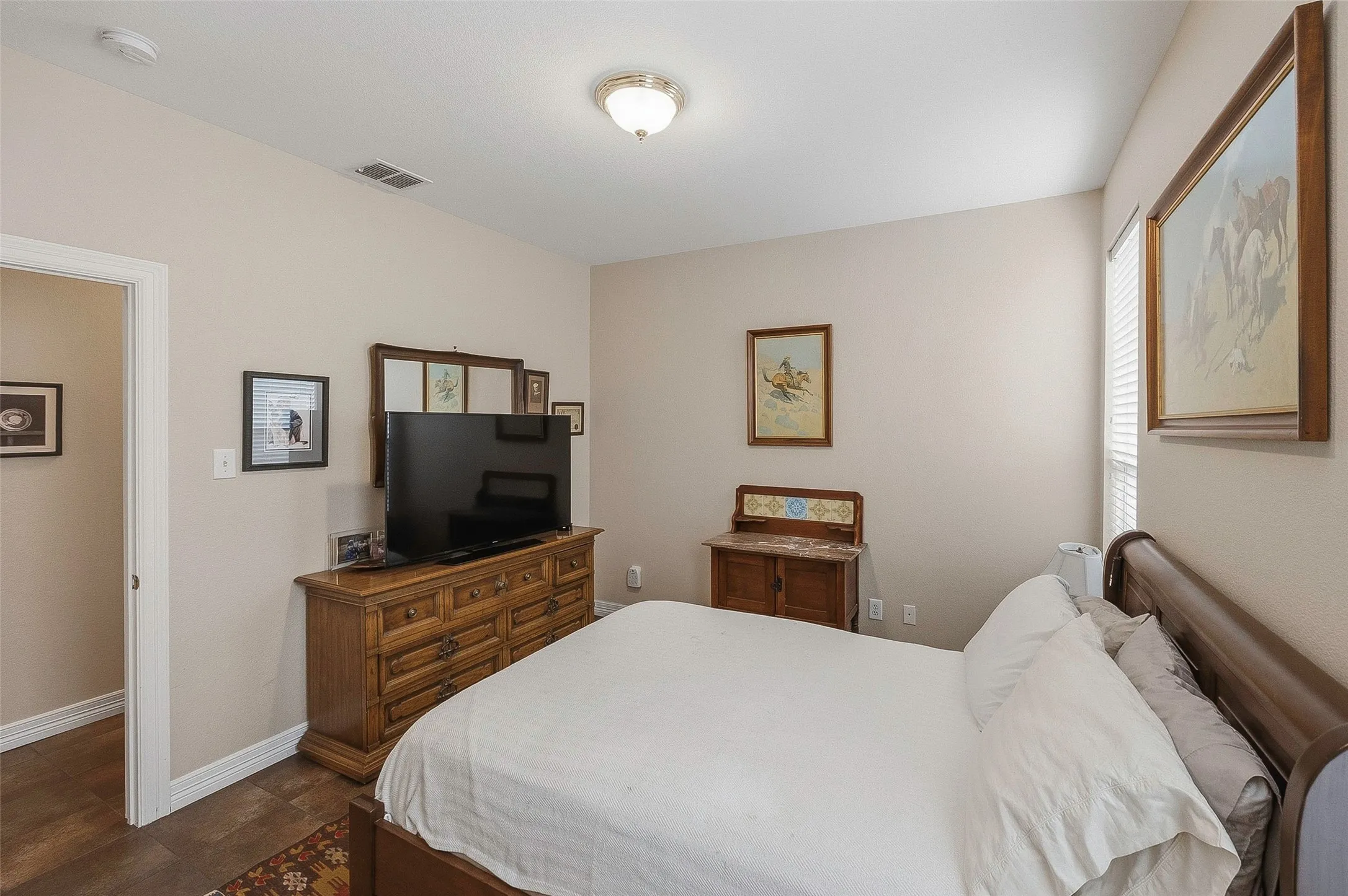 Recessed lighting, wood-finish flooring, neutral wall tones, and a window with blinds