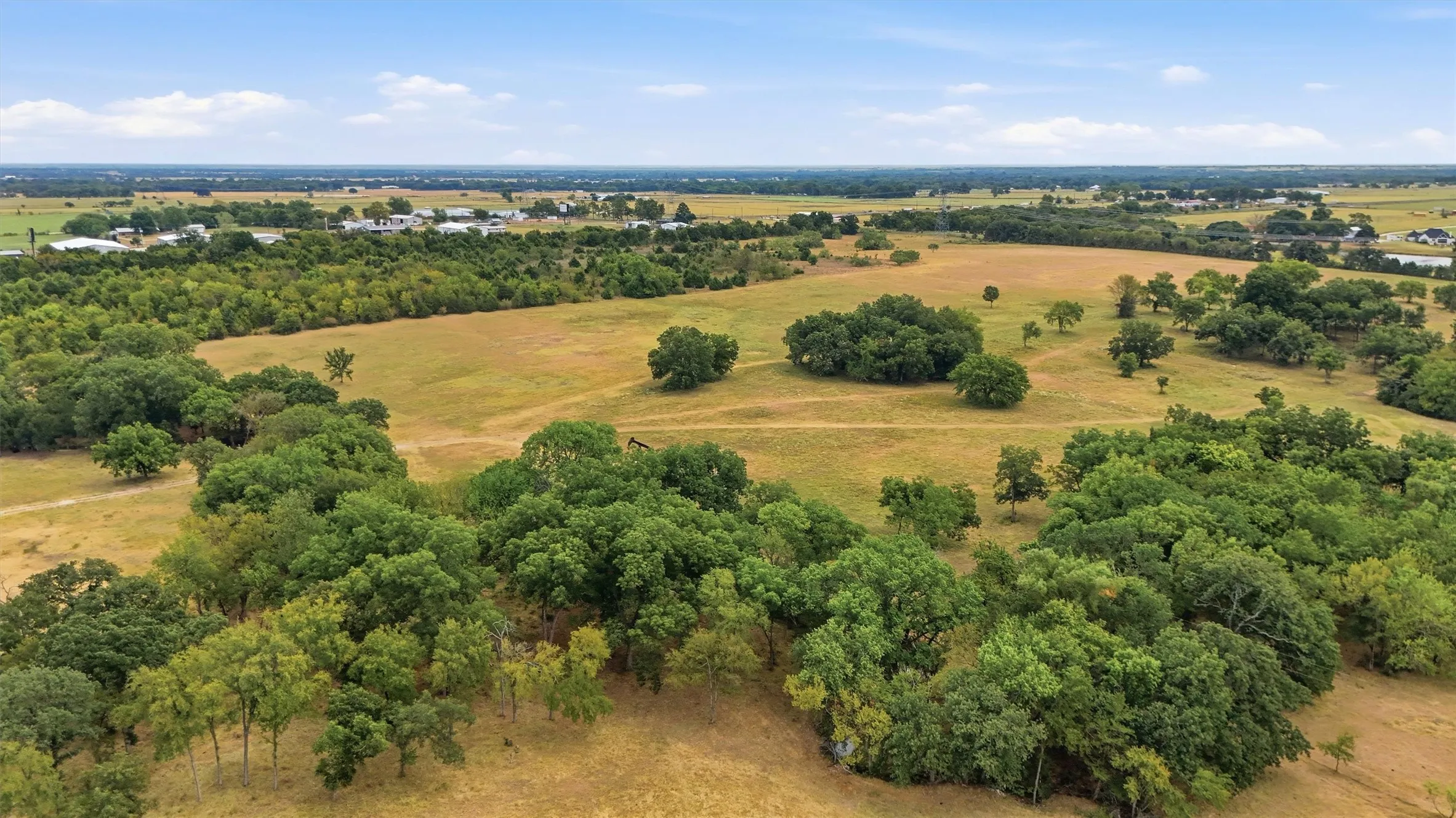 Expansive property featuring wooded areas and open fields