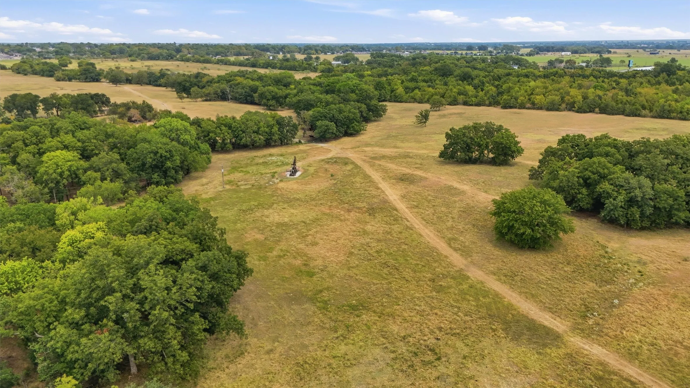 Expansive open land featuring wooded areas and natural terrain