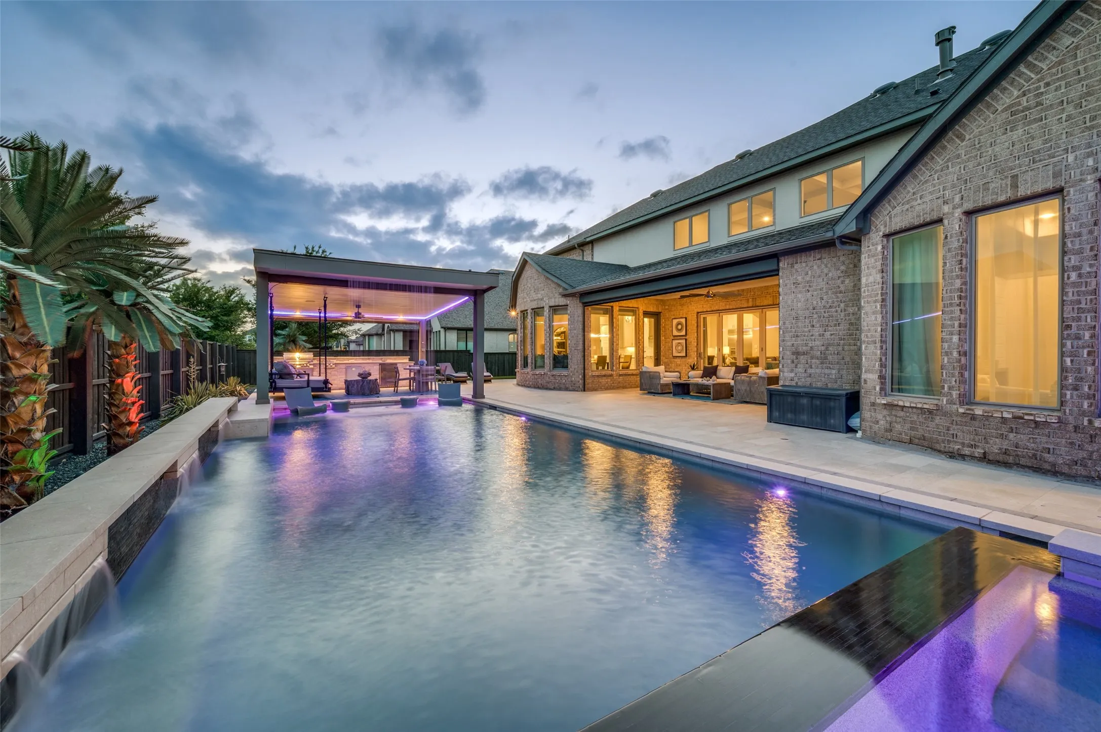 Resort-style pool with integrated water features and a covered outdoor entertaining area