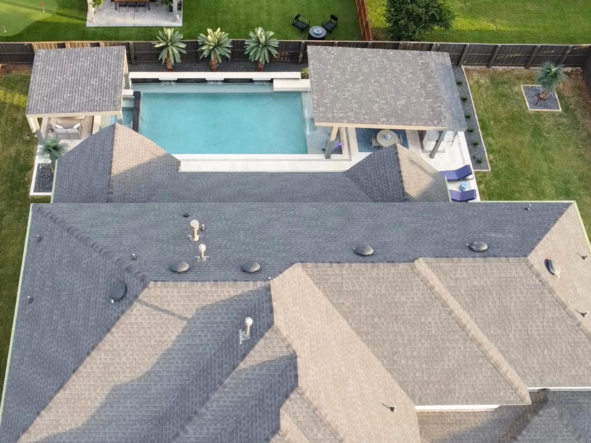 Expansive backyard featuring a rectangular swimming pool, integrated spa, and a covered pergola