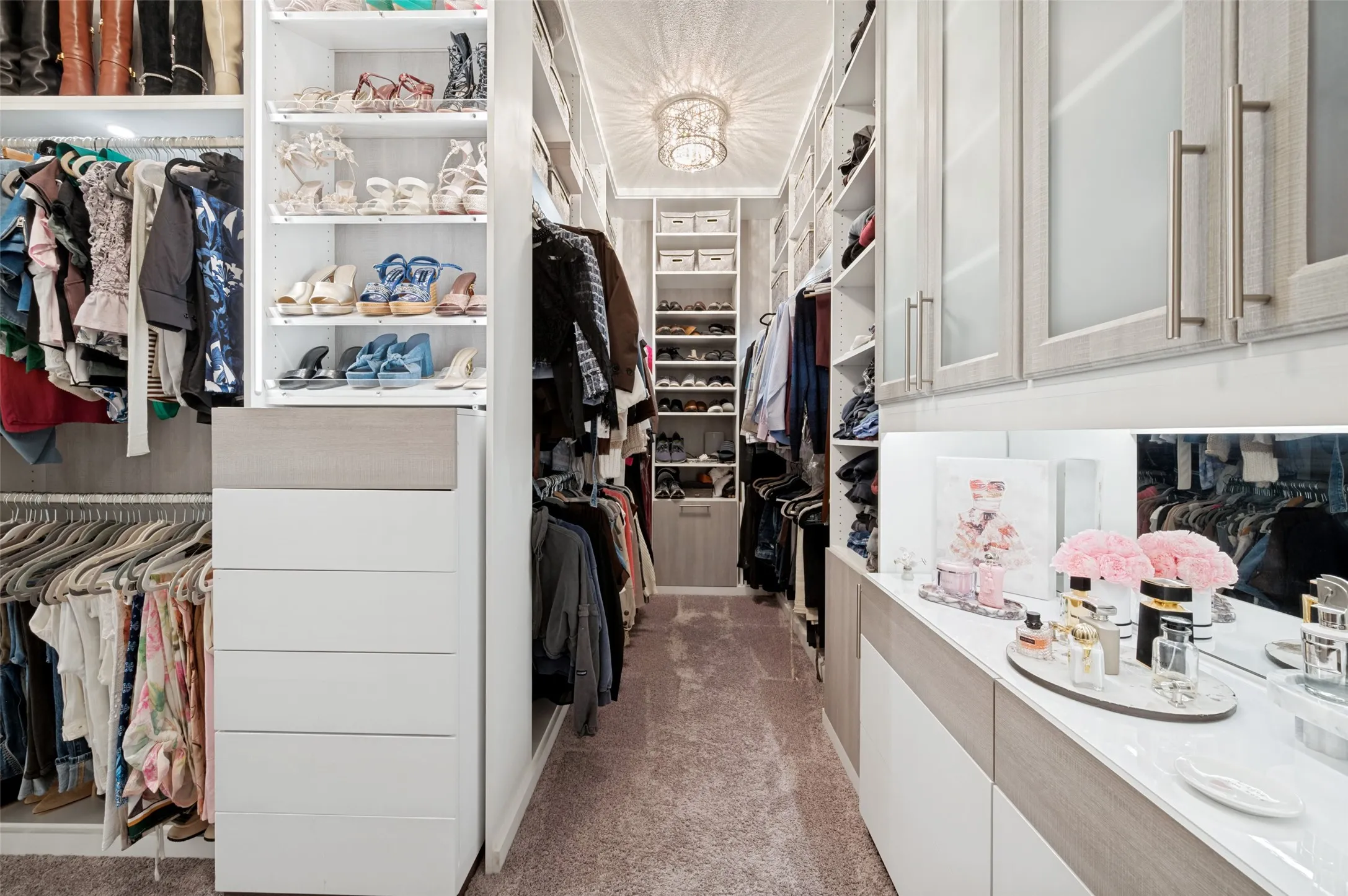 Custom closet system featuring extensive shelving, built-in drawers, and abundant hanging space