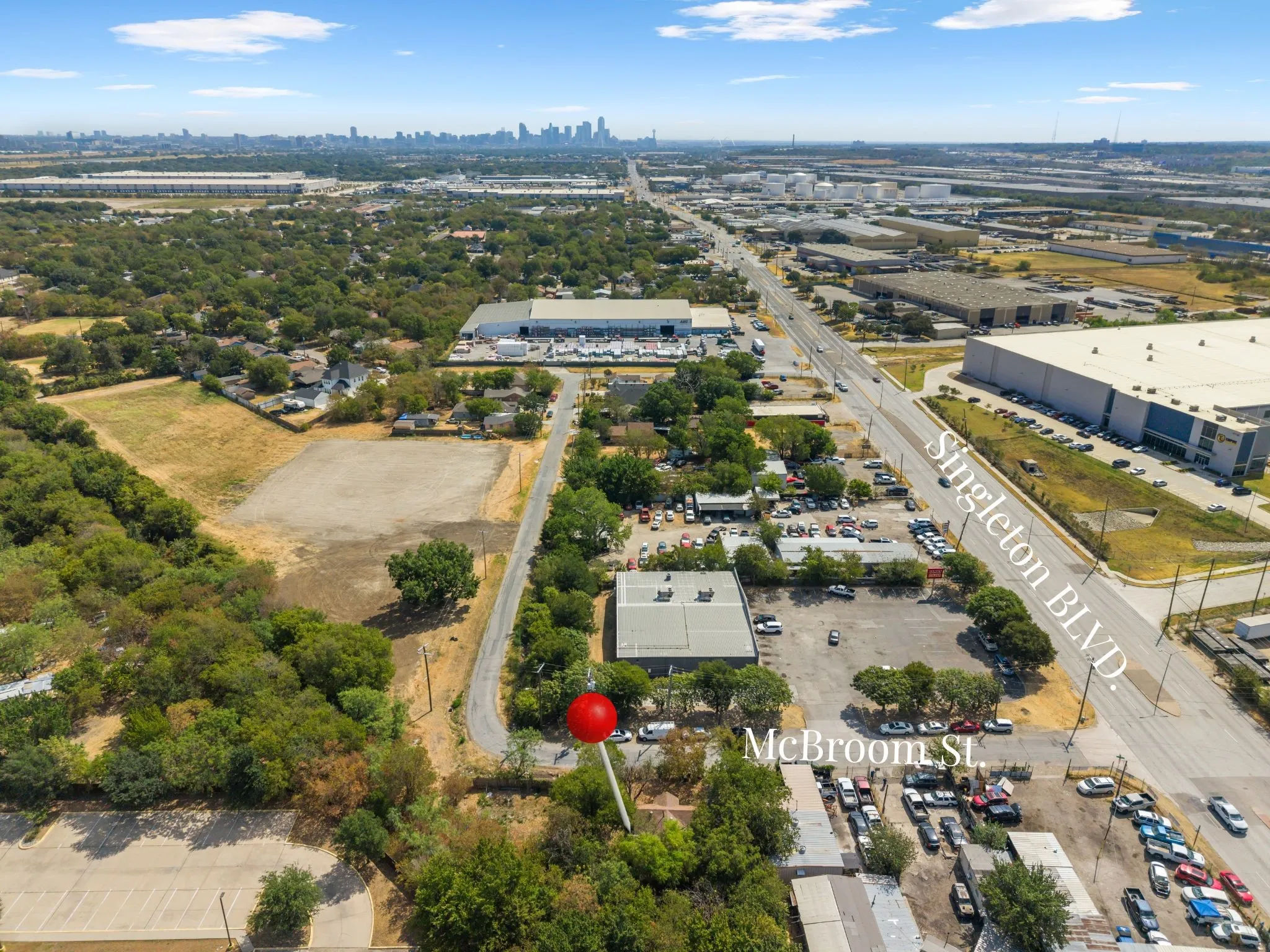 Expansive lot featuring street frontage on McBroom Street, proximity to Singleton Boulevard, and a distant city skyline