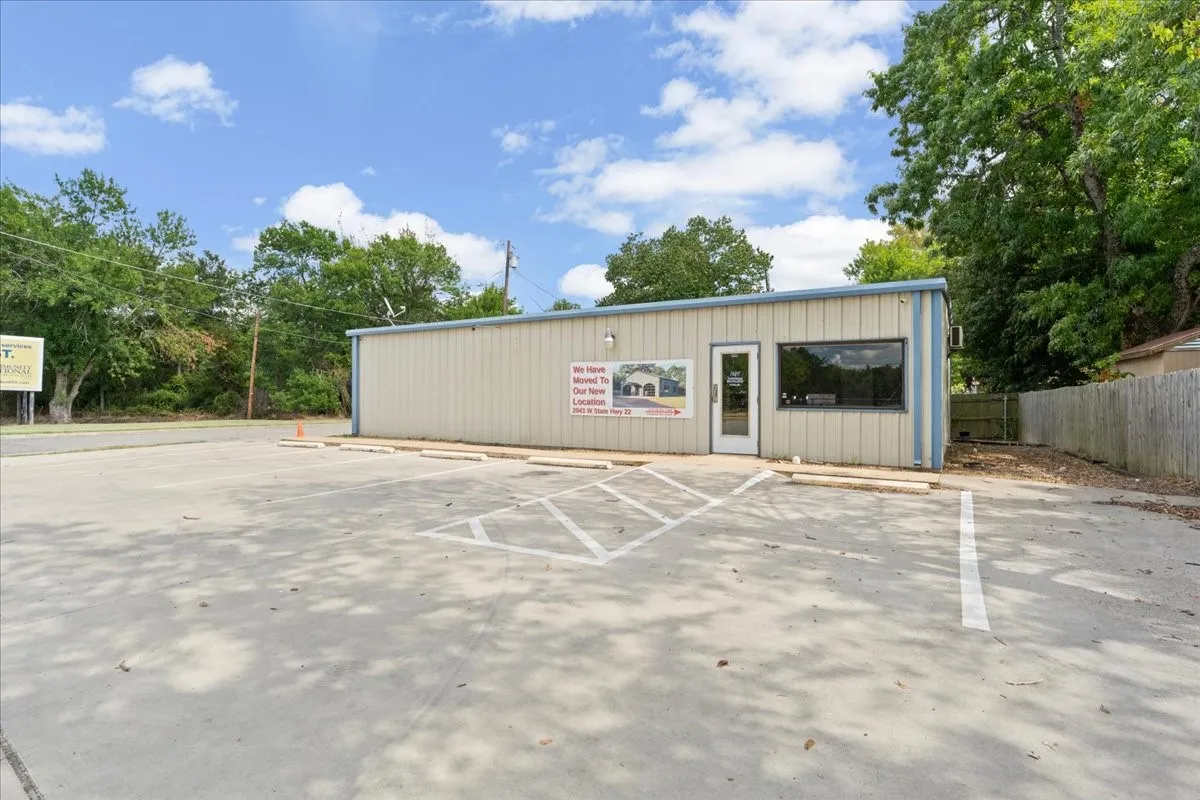 Building with a panel exterior, storefront window, and an entry door