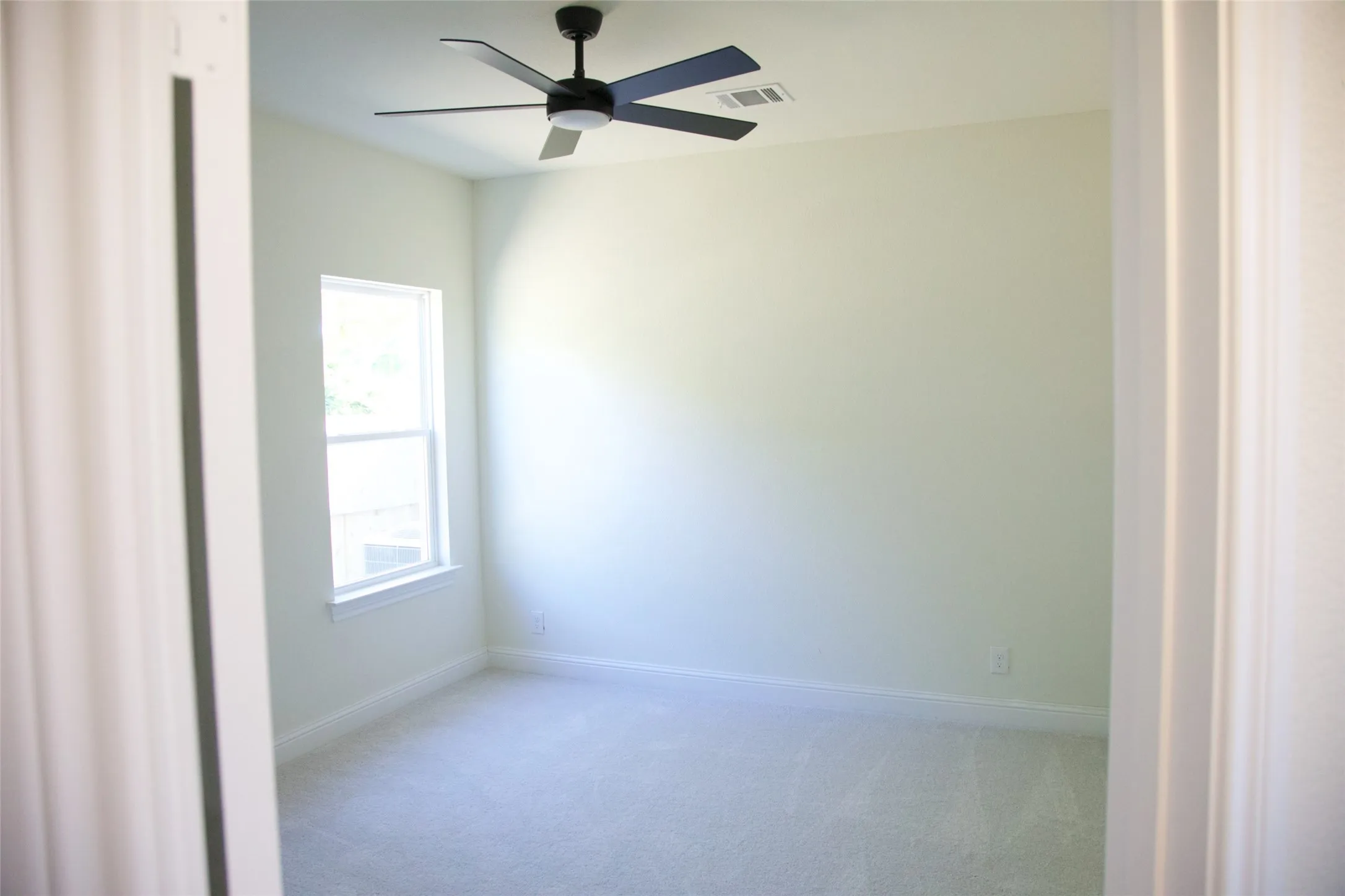 Recessed lighting with a ceiling fan, light-colored walls, white trim, and light-colored carpeting