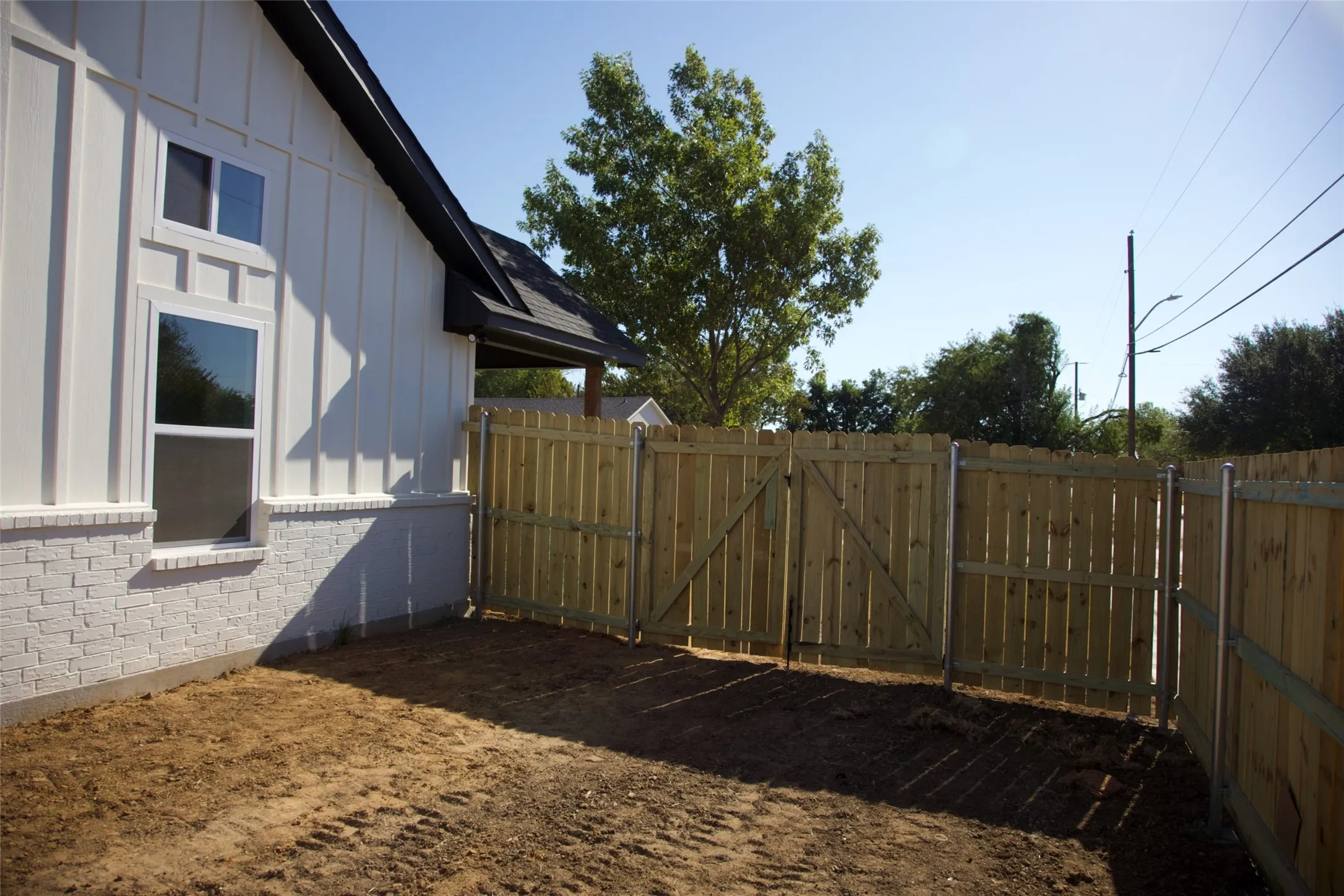 White board-and-batten siding with white brick wainscoting