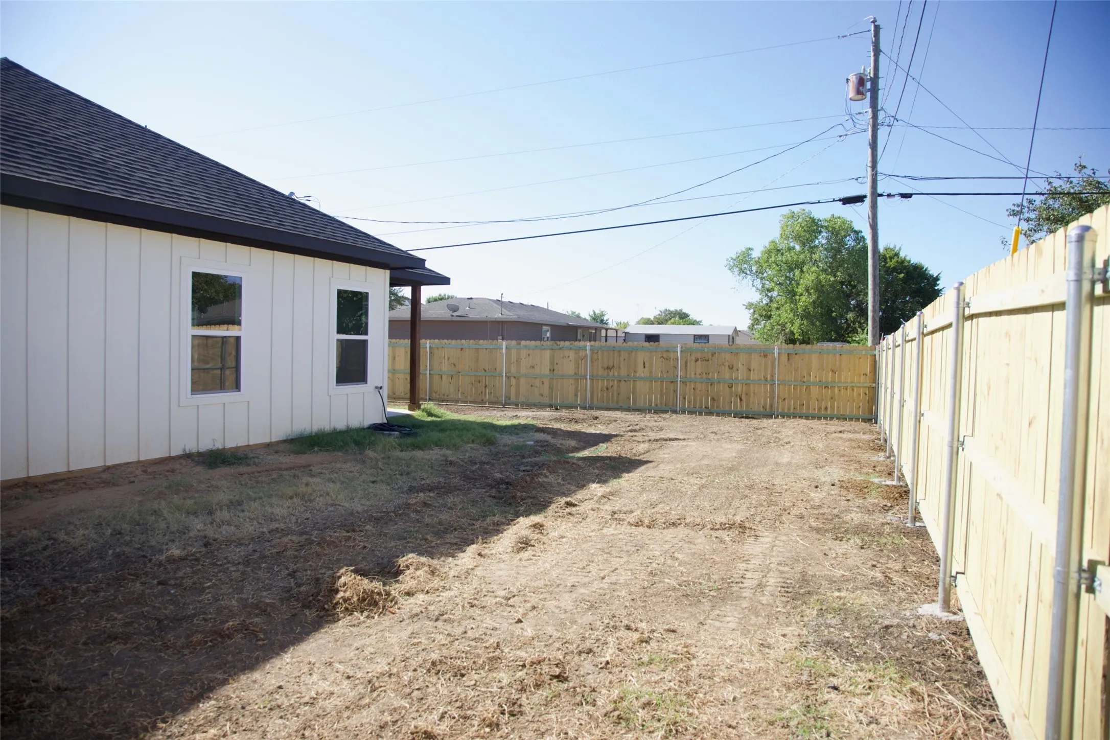Newly installed privacy fence enclosing the property