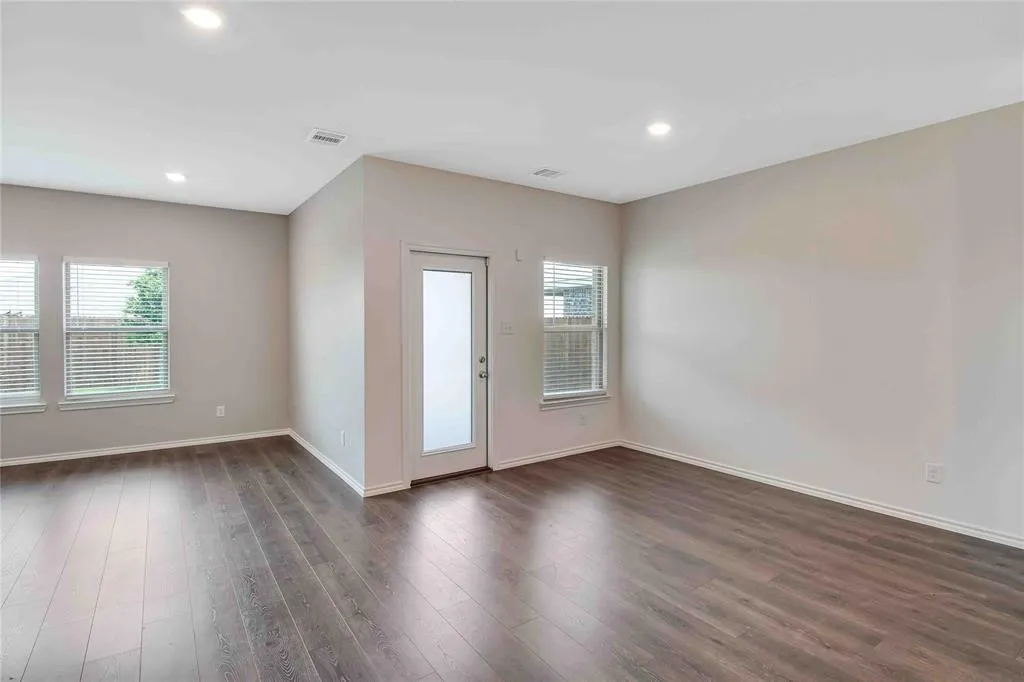 Empty room with dark hardwood / wood-style floors