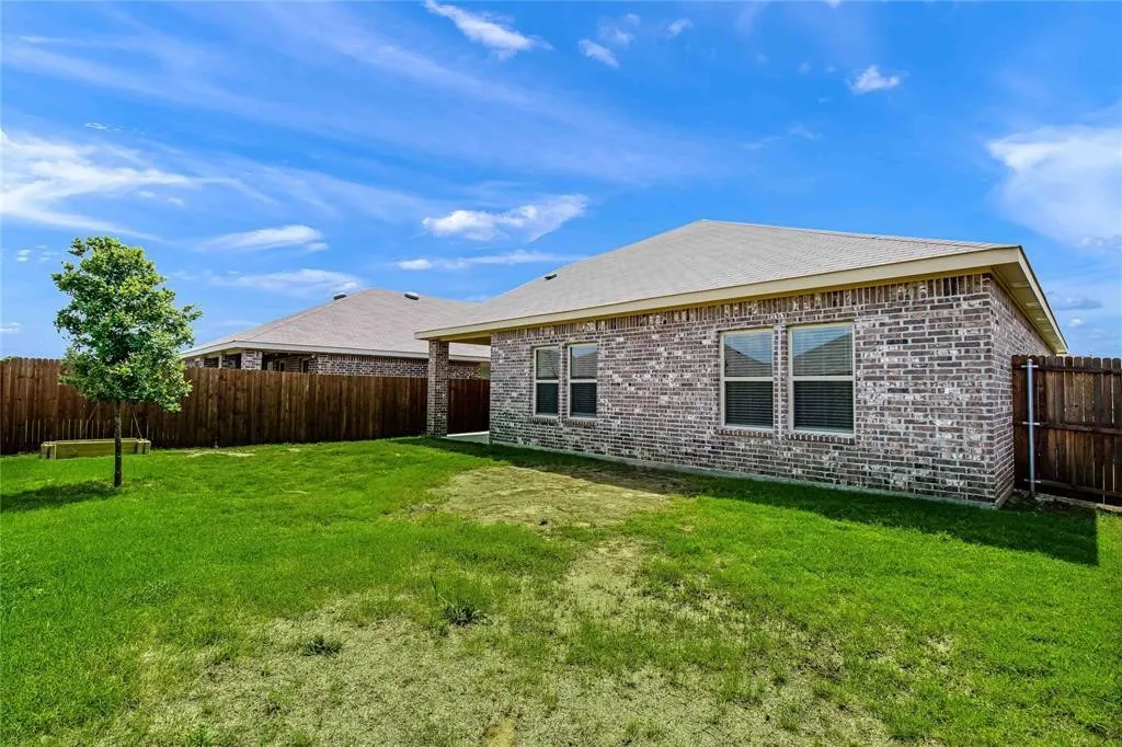Rear view of house with a lawn