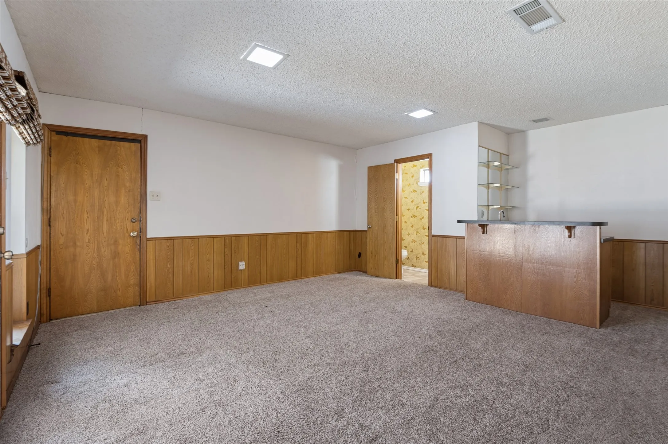 Den with wet bar & half bath