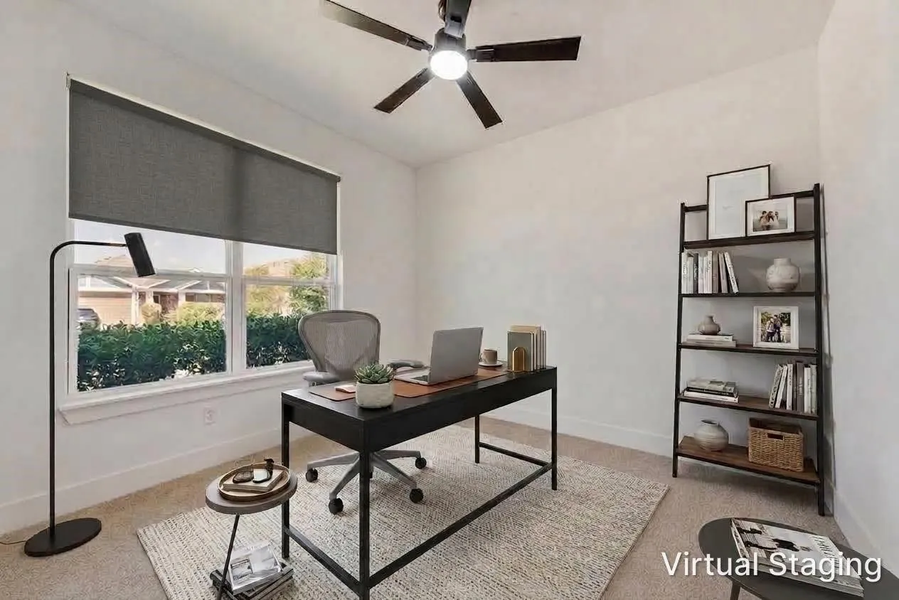 Bright room with a large window, roller shade, and ceiling fan