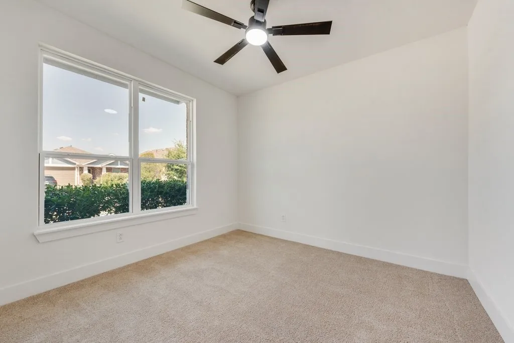 Neutral-toned carpeting, white walls, and a contemporary ceiling fan with integrated lighting
