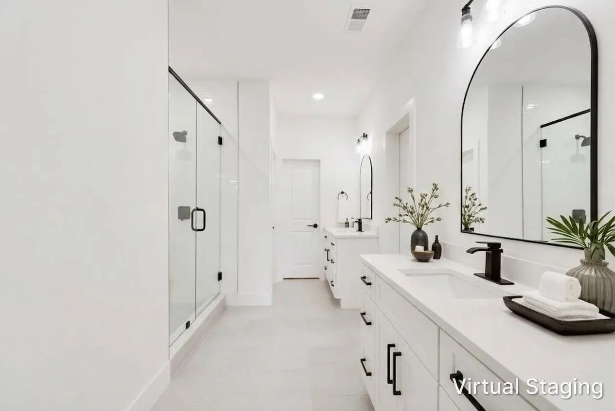 White vanity with integrated sink, black hardware, arched mirrors, and a glass-enclosed shower