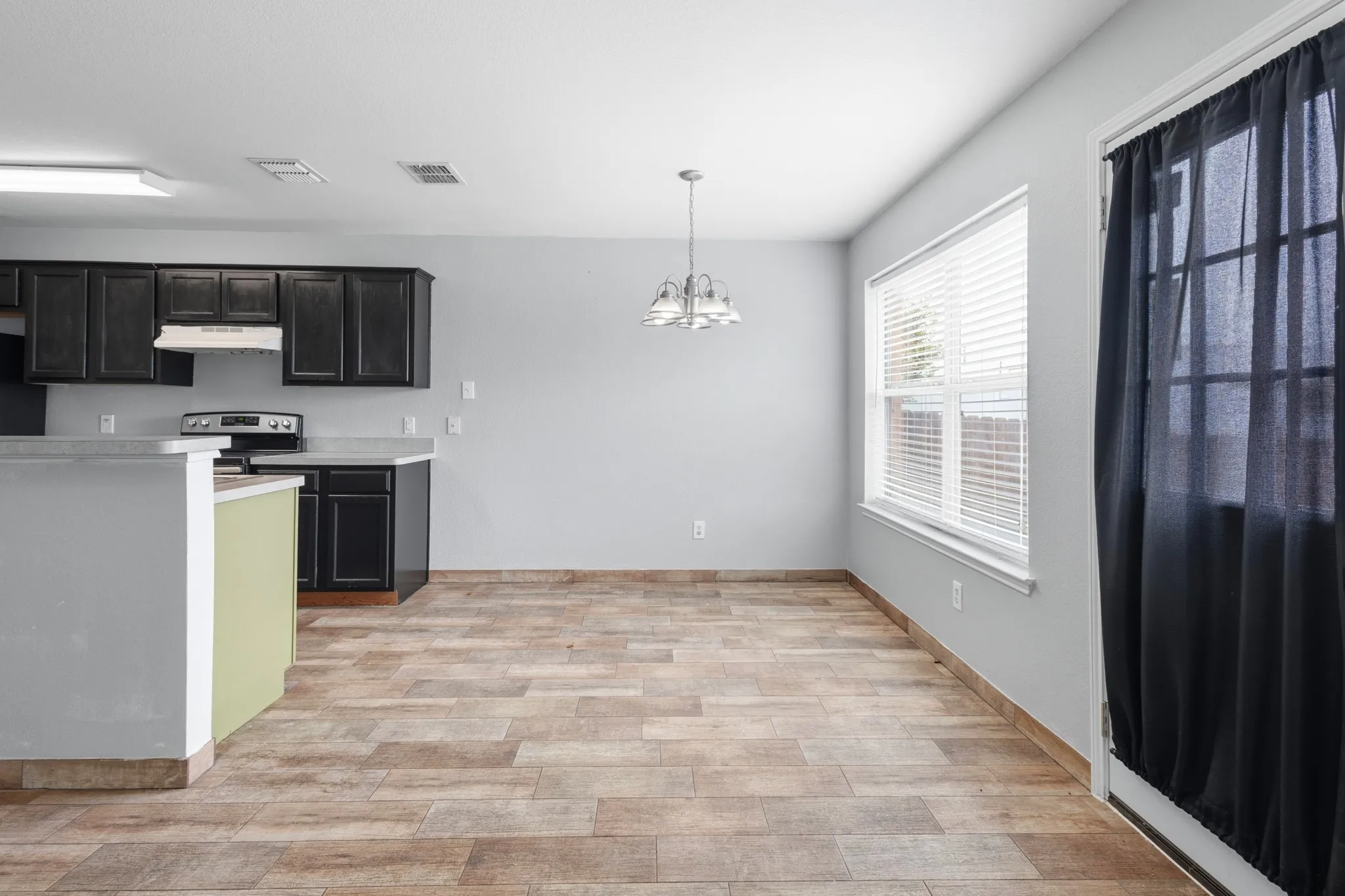 Kitchen featuring dark cabinetry, light countertops, and stainless steel appliances
